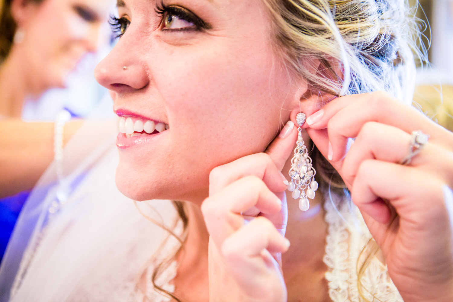  Bride putting her earrings in.&nbsp;The barn at Evergreen Memorial. Photographed by JMGant Photography. 
