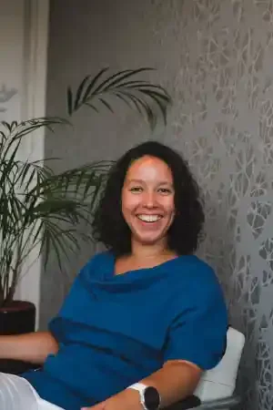 Een lachende Sarah Getu zittend in haar praktijk omdat haar Square Space website live is gezet door Made by Anouk Squarespace website designer