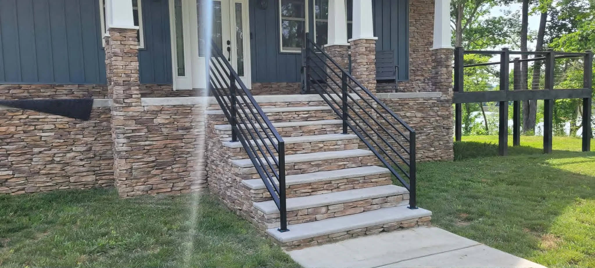 custom made metal handrails using metal square tube, horizontal spindles mounted to concrete
