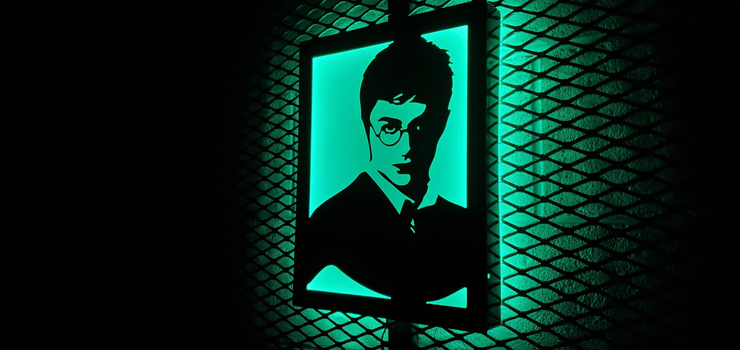 Neon sign of a person's silhouette with glasses and a mustache against a teal background, mounted on a textured wall.