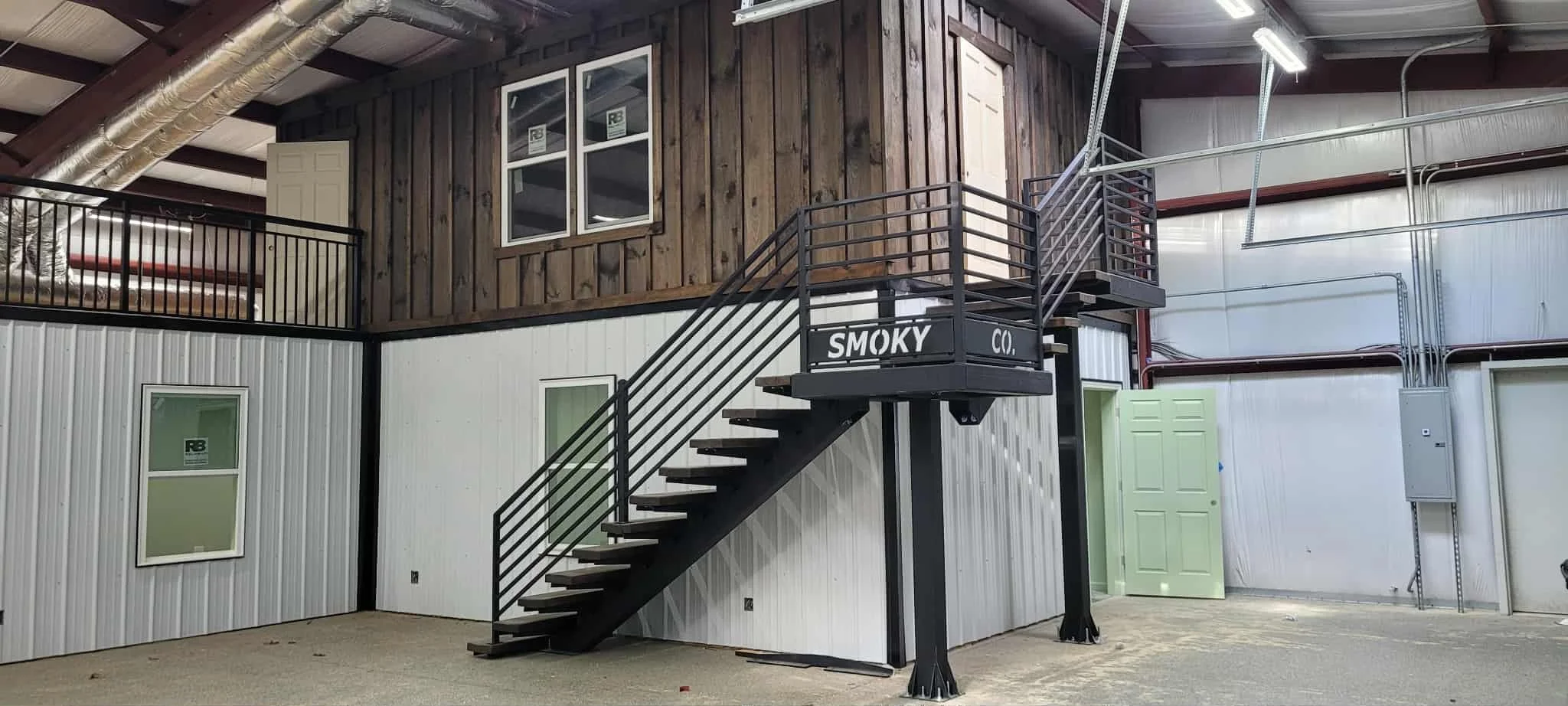 Custom metal staircase with steel railings and hardwood treads fabricated by Turn 2 Customz in Tellico Plains TN