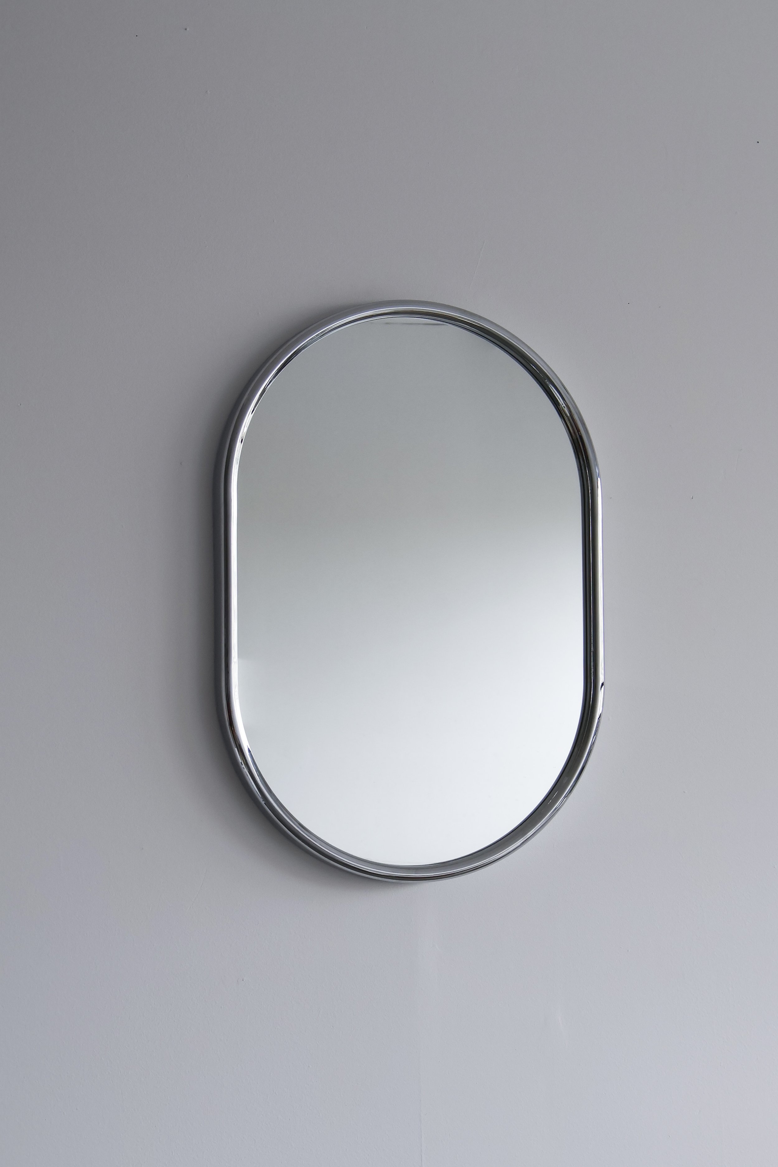 Large 1970s oblong wall mirror with minimalist chromed plastic edge.