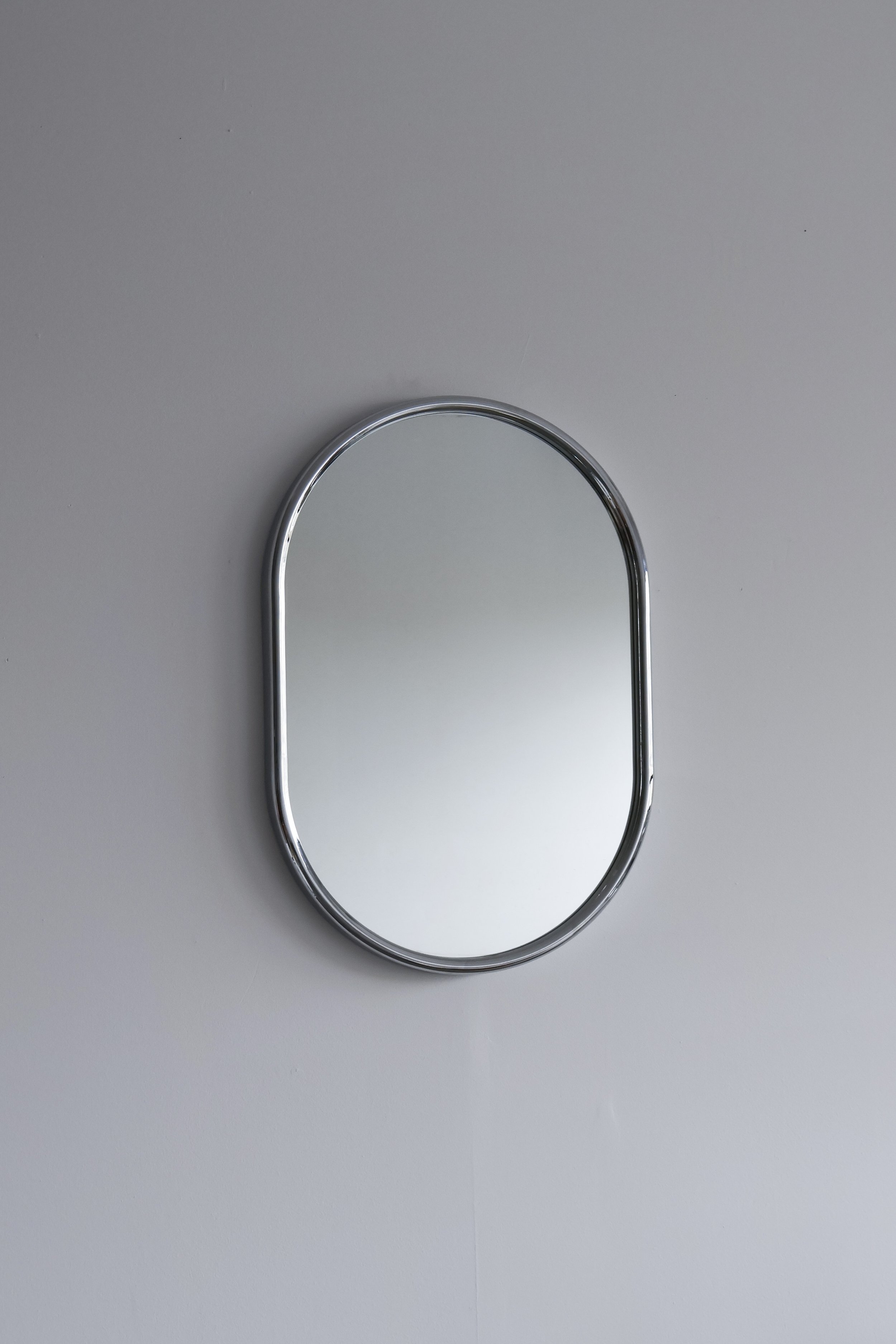Large 1970s oblong wall mirror with minimalist chromed plastic edge.
