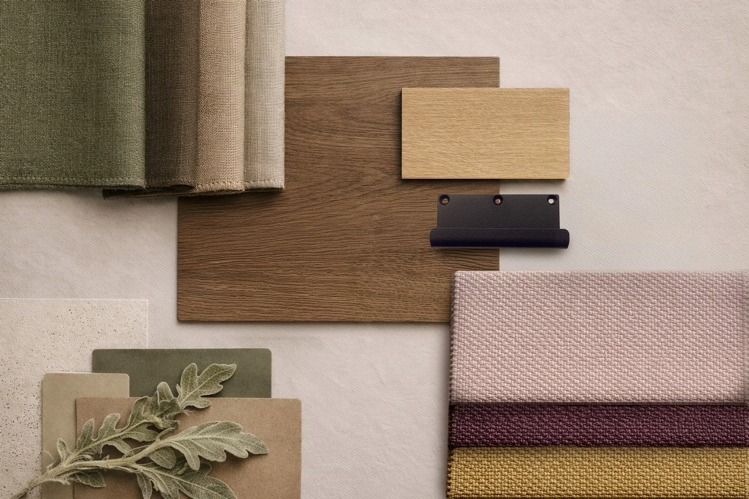 Material palette with fabric swatches, wood-look finishes, a black fitting and a green branch.