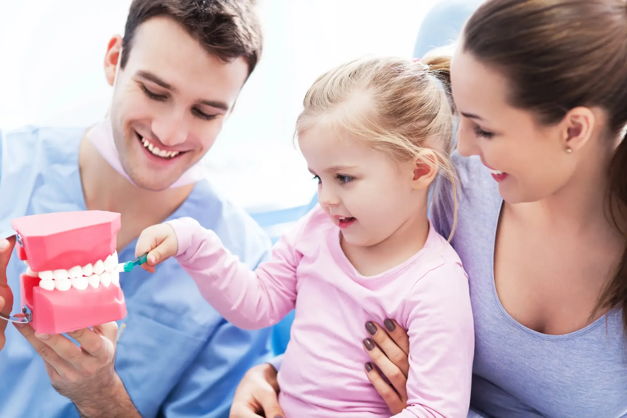 Dentist 32405 teaching girl proper brushing technique