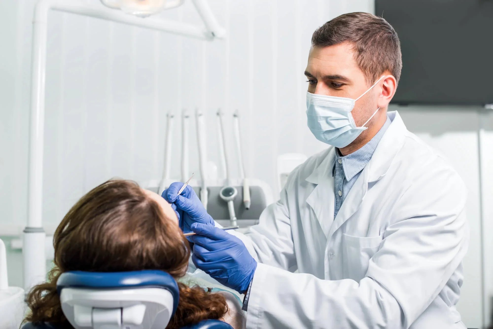 Dentist near Panama City, Florida working with patient at a dental clinic