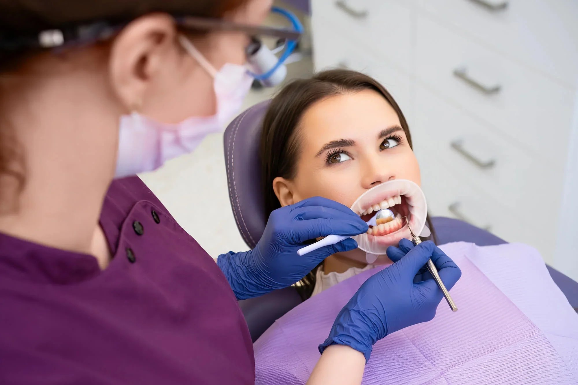 Dentist examining patient for smile makeover in Panama City.