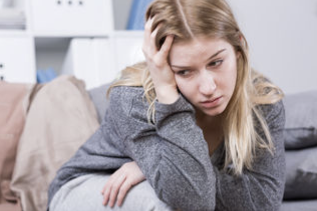 women holding her head in pain