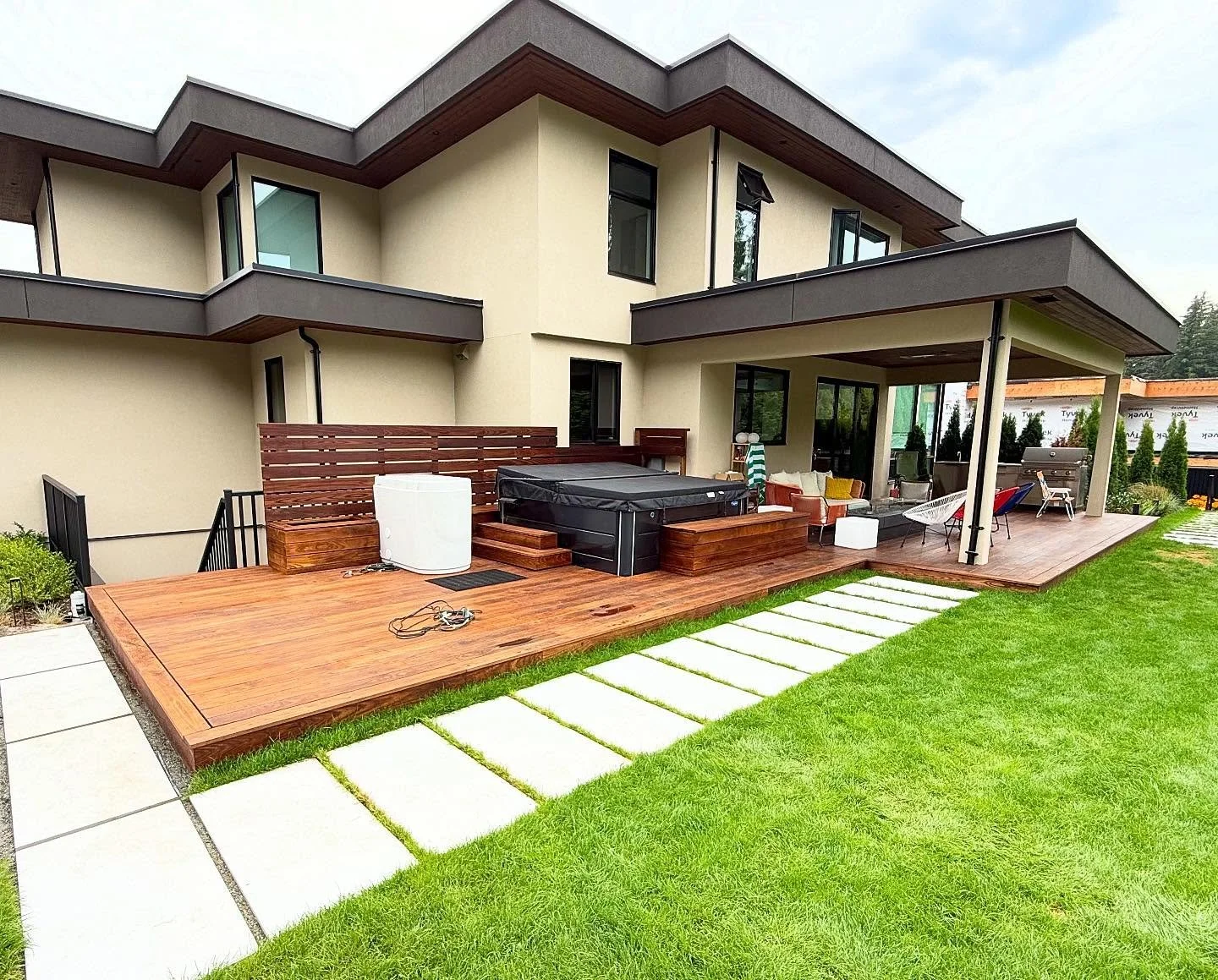 Check out our beautiful thermowood deck we&rsquo;ve built at our Anmore project! On the far right, we&rsquo;ve installed a cozy fire pit and an outdoor kitchen area, complete with heaters for chilly nights. To the left, enjoy a hot tub and a cold plu