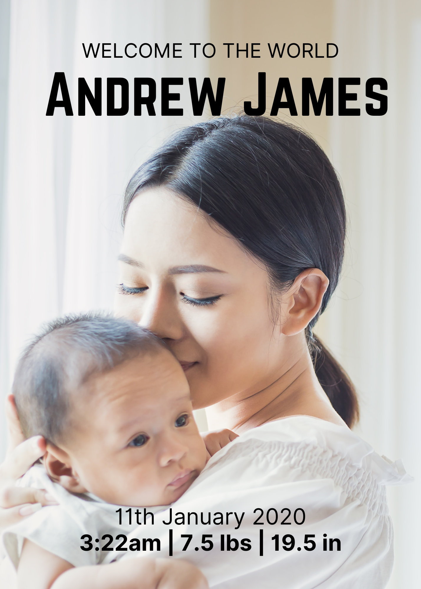 A woman with dark hair holding a baby and kissing its forehead in front of a light-colored background.