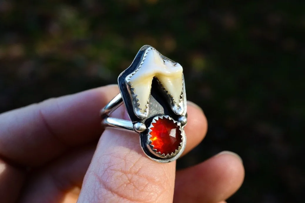 A custom rose cut fire opal and coyote tooth ring I finished up for a client last night! This one brings the heat and I just had to show off the stone in different lighting to do it justice. This baby glows! All handmade with sterling and fine silver