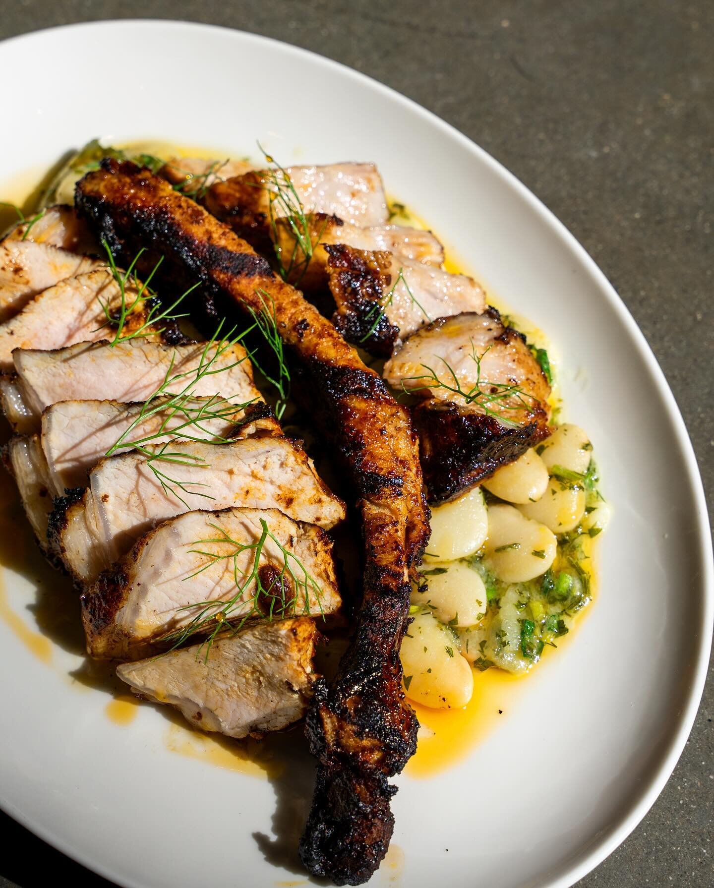 One of several new dishes on the menu this week! 

Smoked Harissa Mohawk Pork Chop with Salsa Verde Butter Beans. We love the Mohawk chop at Mayfield as it gives you the best of both worlds, chop on one side and the belly on the other!

#chef #restau
