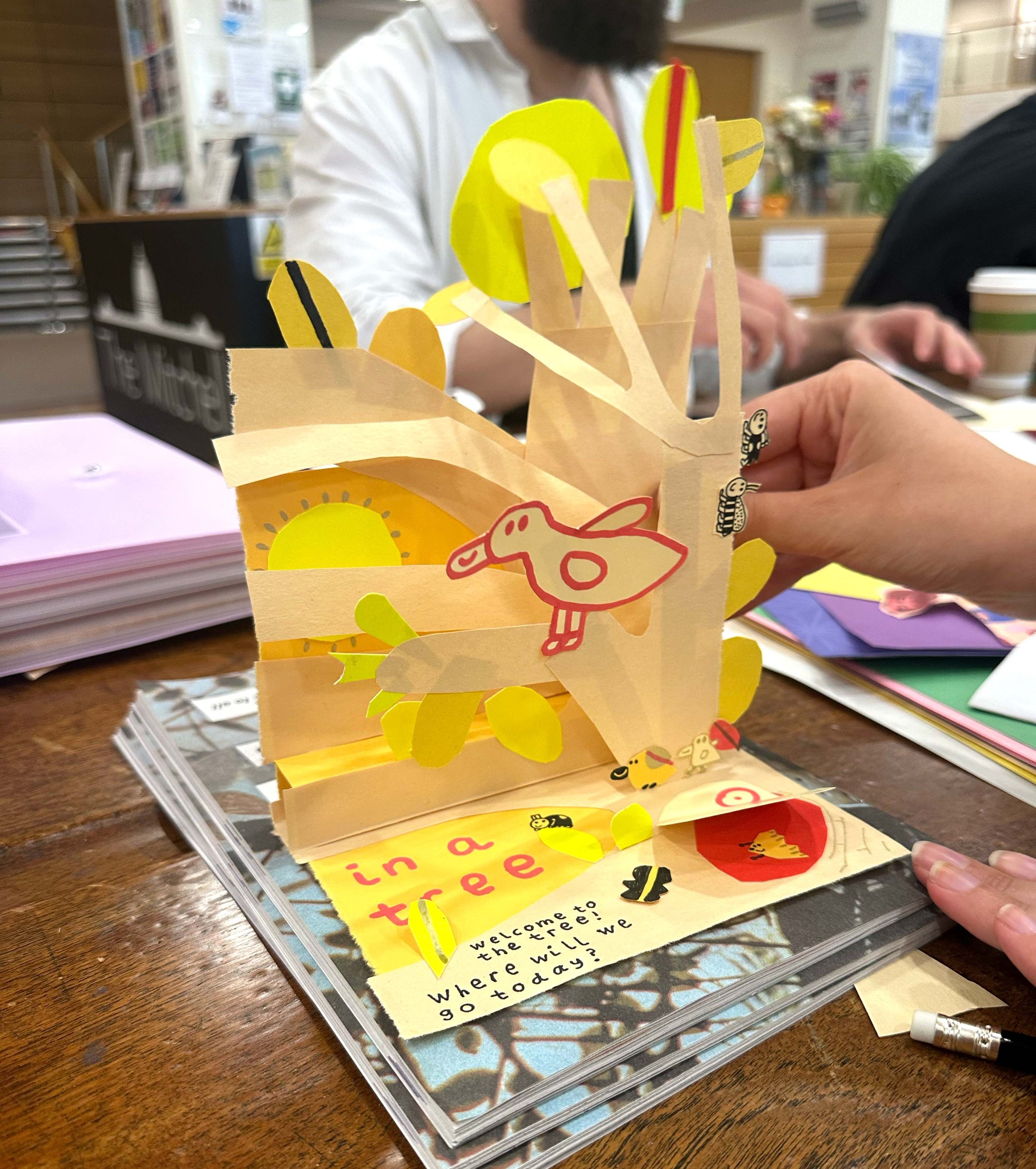 Participants creating paper pop-up illustrations during a family art workshop in Glasgow. Classes led by the illustrator Jagoda Sadowska.