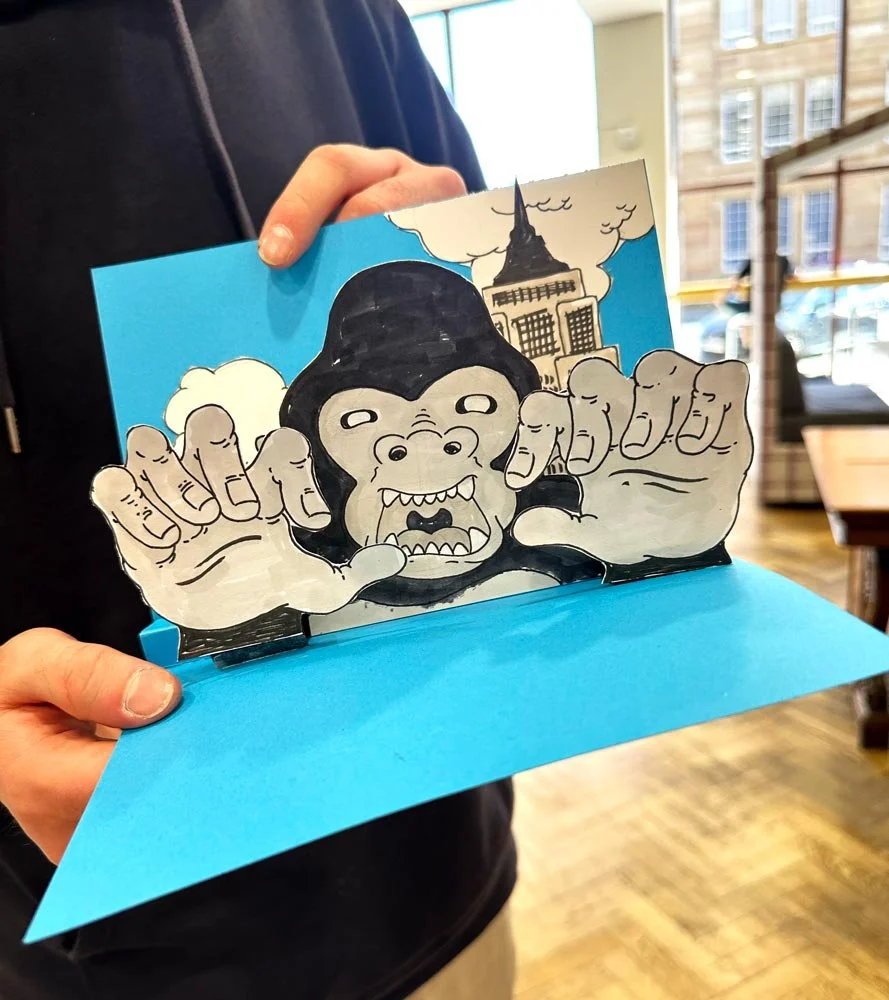 Participants creating paper pop-up illustrations during a family art workshop in Glasgow. Classes led by the illustrator Jagoda Sadowska.