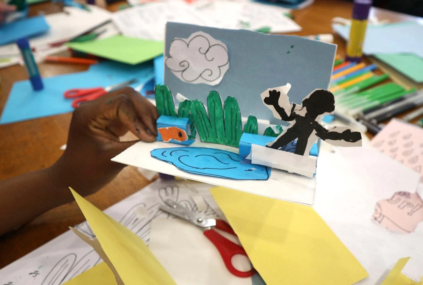 Participants creating paper pop-up illustrations during a family art workshop in Glasgow. Classes led by the illustrator Jagoda Sadowska.