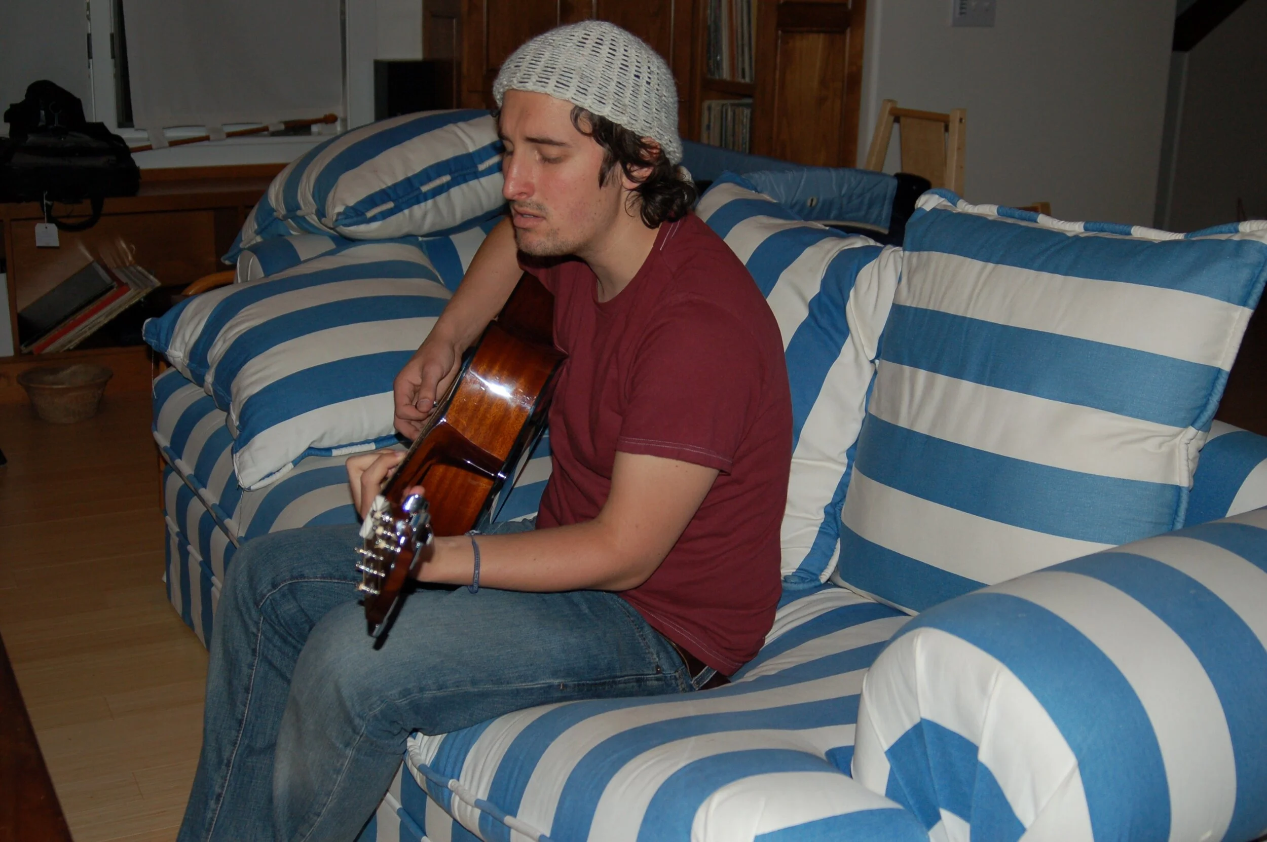 Danny playing gutiar on the sofa.JPG
