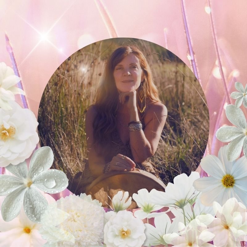 Angela Prider surrounded by white flowers representing the Celtic Fire Festival of Imbolc