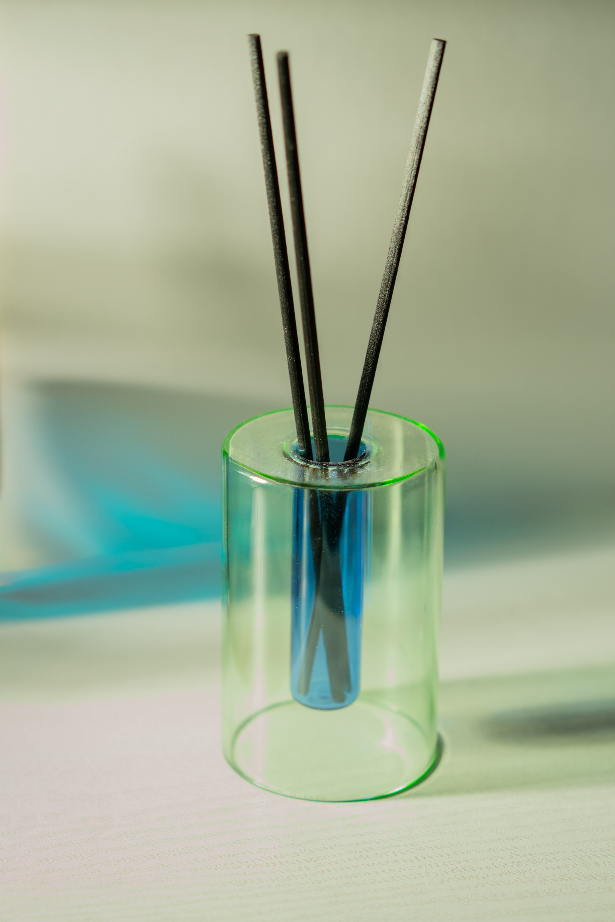 Green diffuser with blue background.png