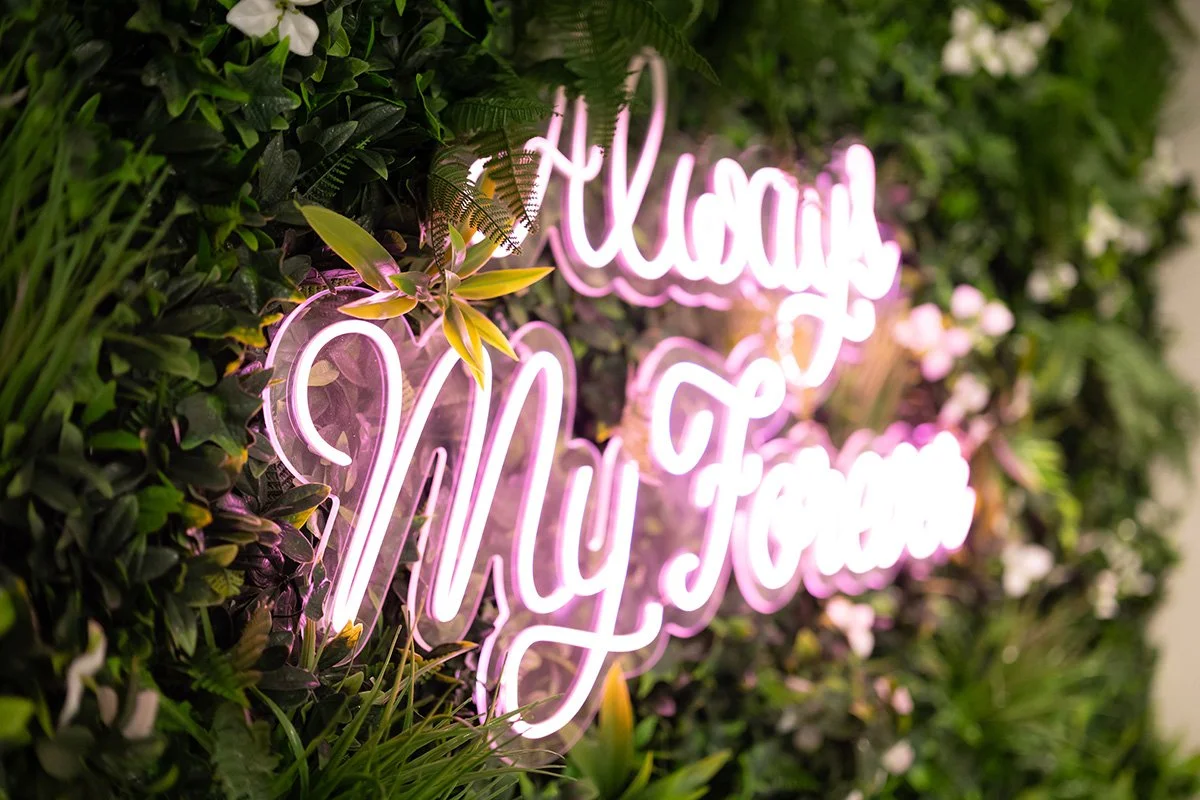 Everglow Jewelry store interior greenery wall with neon sign reading Always My Forever