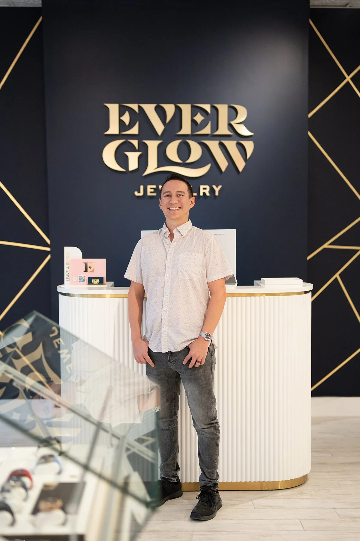 Everglow Jewelry store interior with owner Derrick posed at front