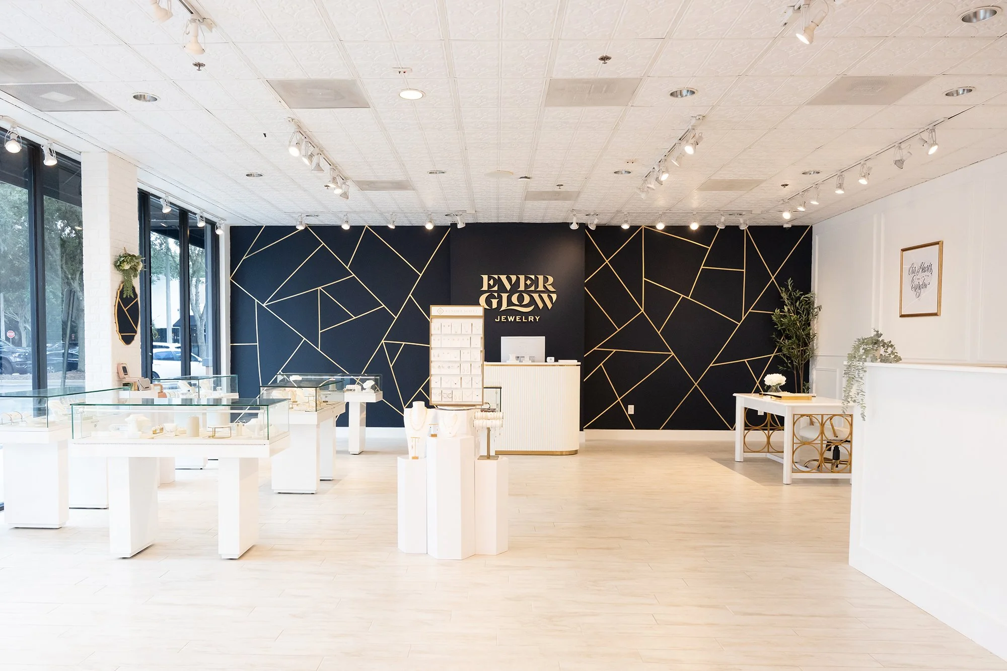 interior photo of wall mural and jewelry cases for Everglow Jewelry