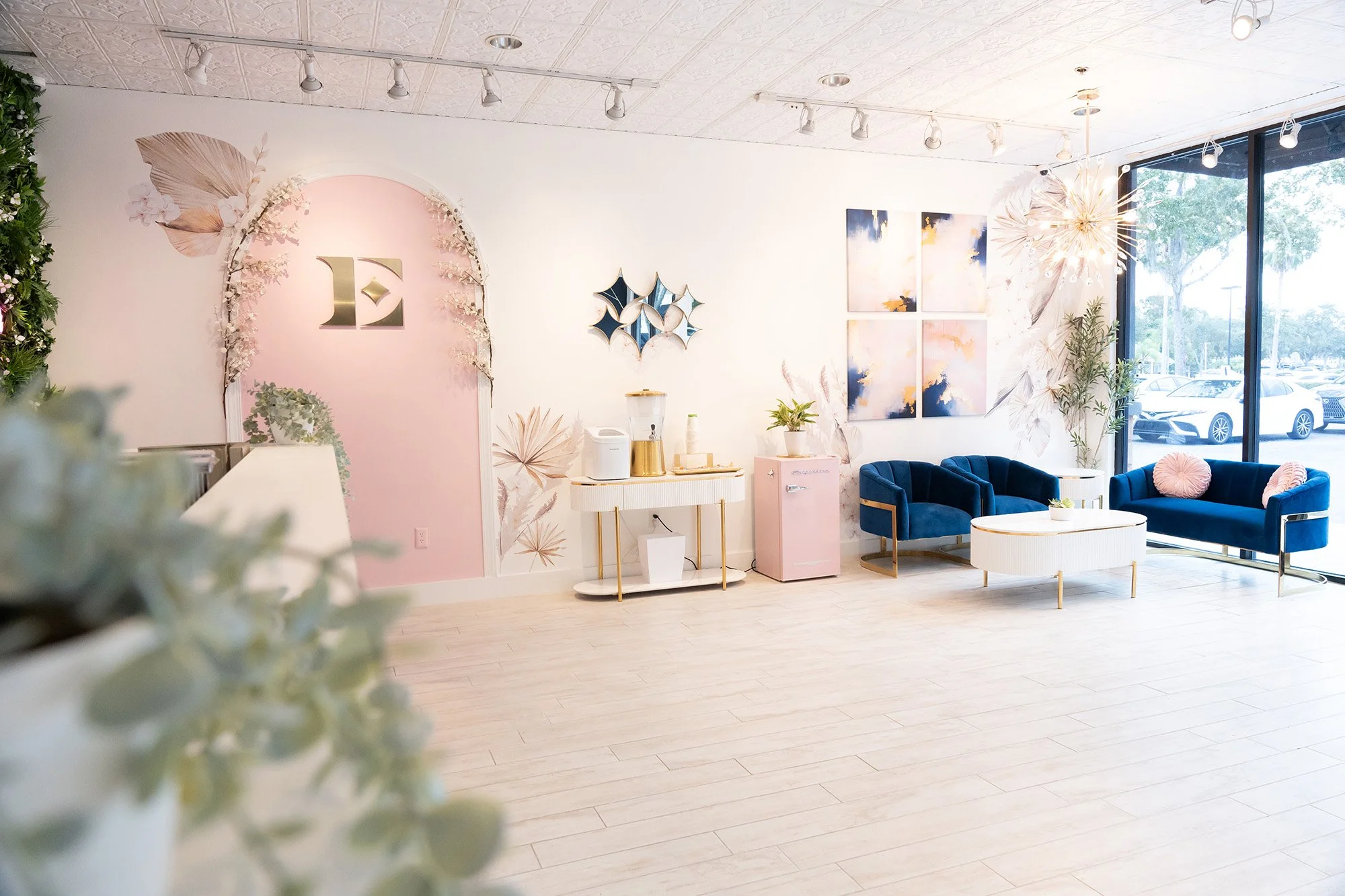 Everglow Jewelry store interior with pink walls and blue couches