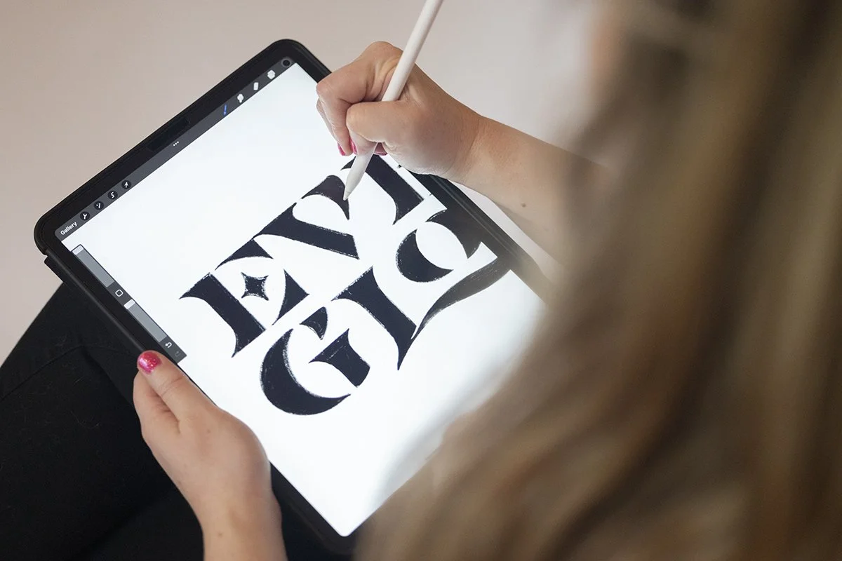 Rachel sketches concept for Everglow Jewelry logo on her iPad