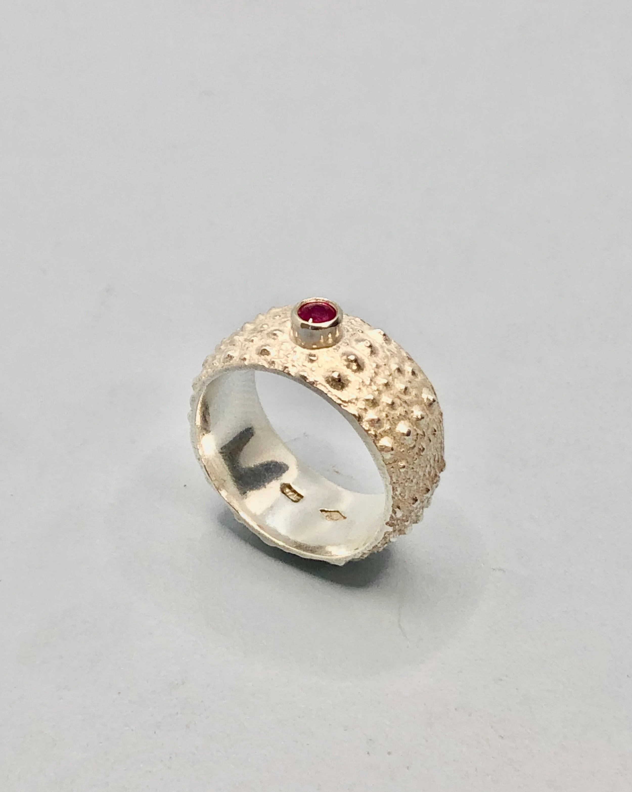 Ruby set in sterling silver on a sea urchin textured 925 ring band