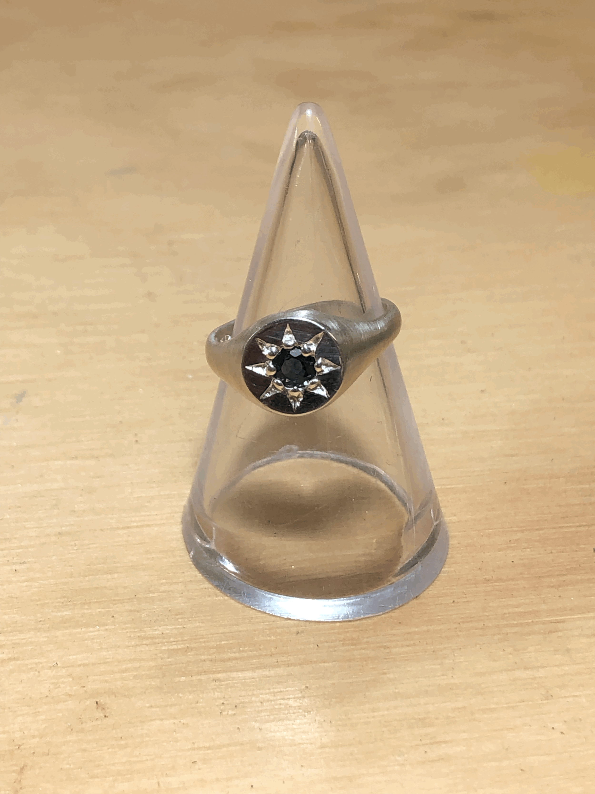 Front view of sterling silver signet ring showing 3mm tapered band width, blue sapphire setting