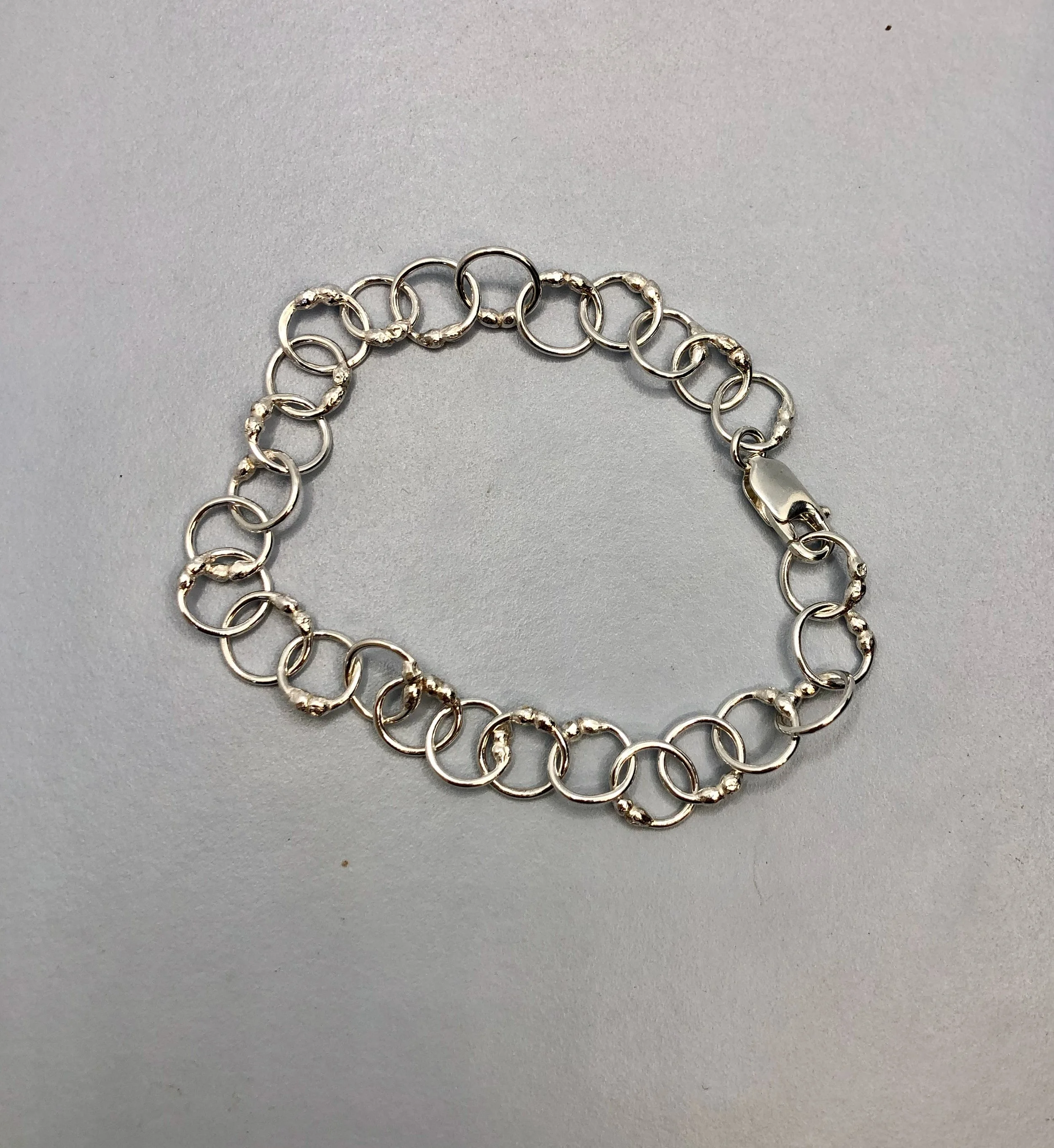 Handmade sterling silver ball-link chain bracelet shown closed with secure lobster clasp