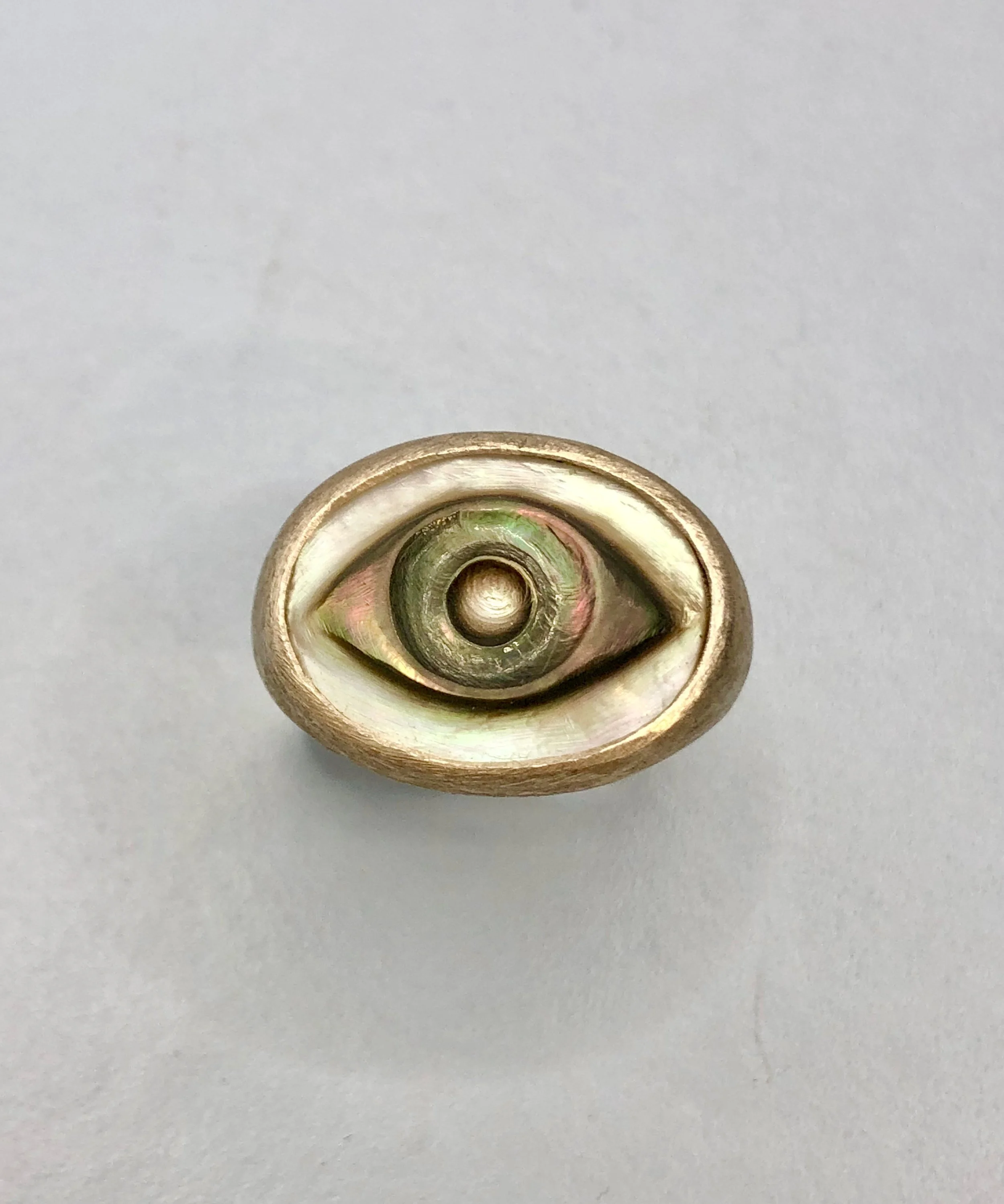 Top down view of mother of pearl cameo ring, showing colour and iridescence of the pearl.