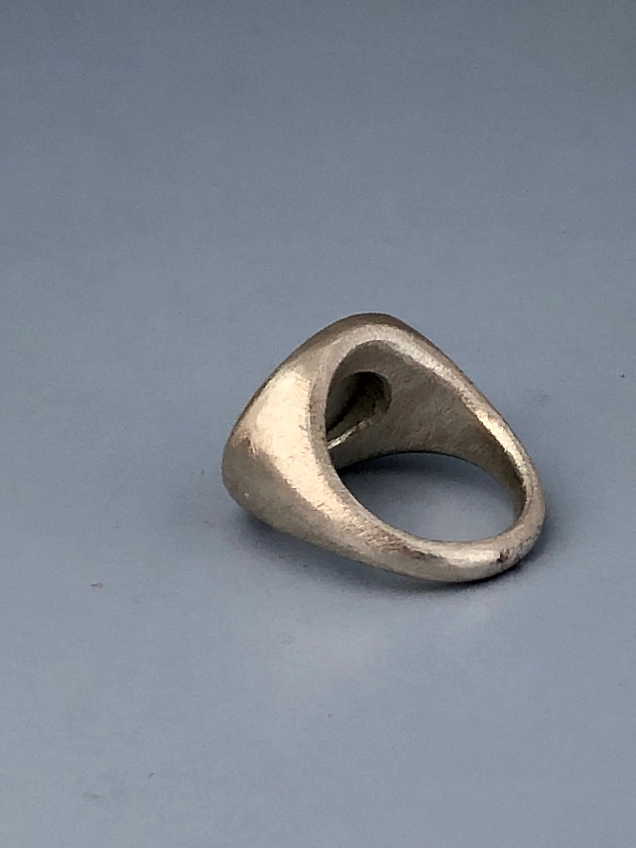 Underside view of mother of pearl and silver eye ring showing shape and taper of the 925 band.