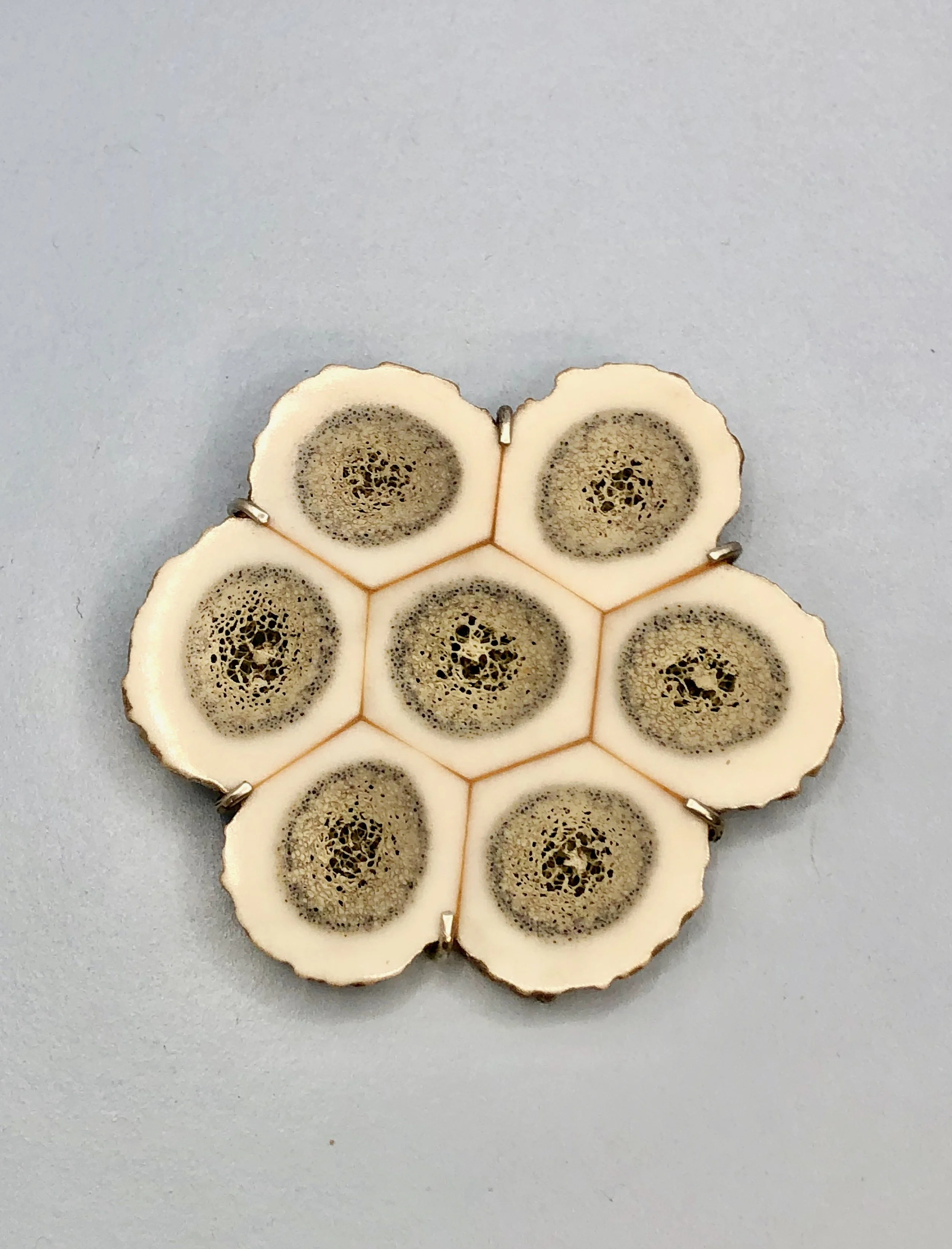 Front view of cross-section antler brooch