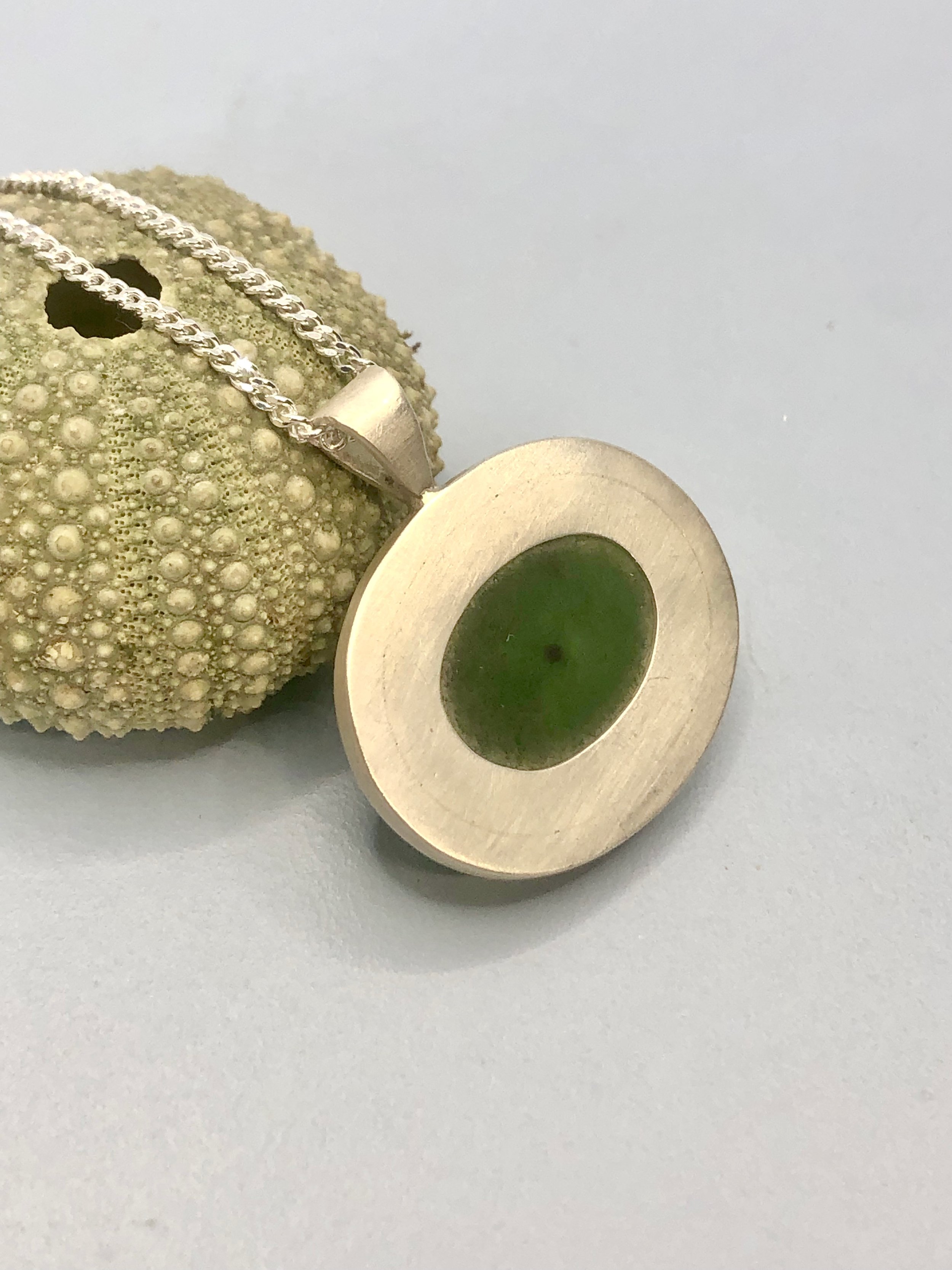 Reverse of pounamu dome pendant