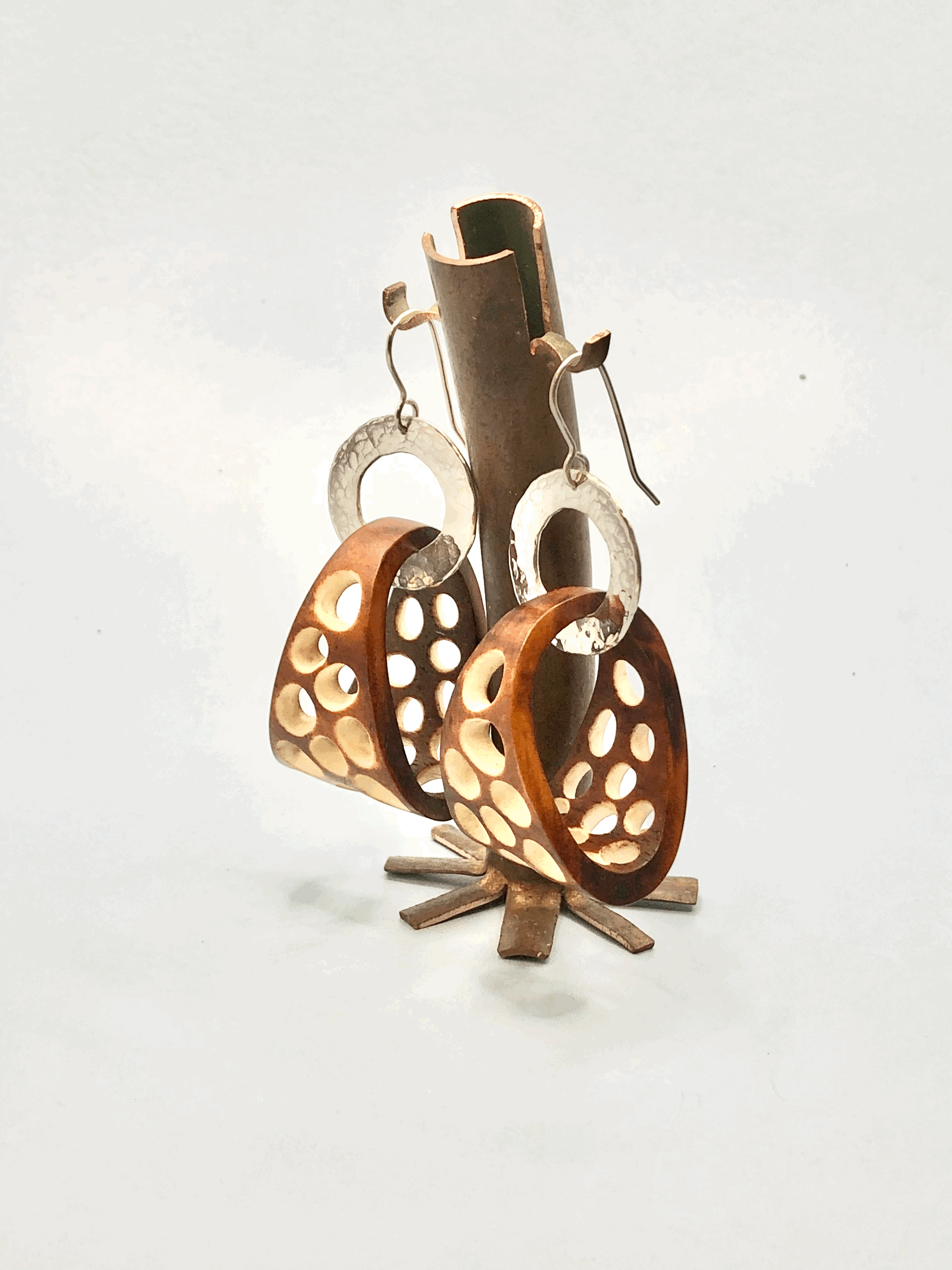 Side view of carved antler basket hoop earring showing natural dye colour and texture
