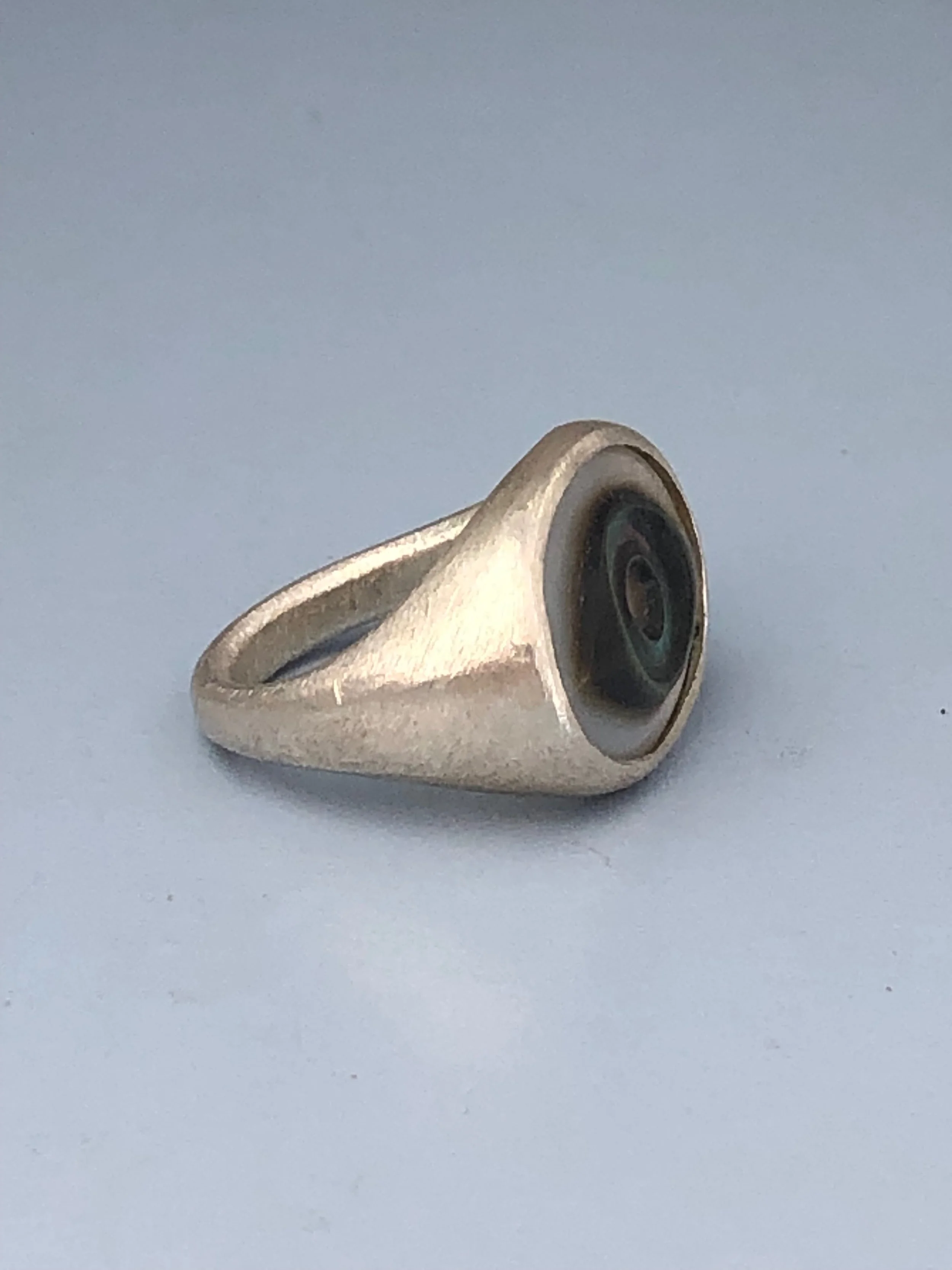 Side view of silver eye ring to show shape and taper of the band.