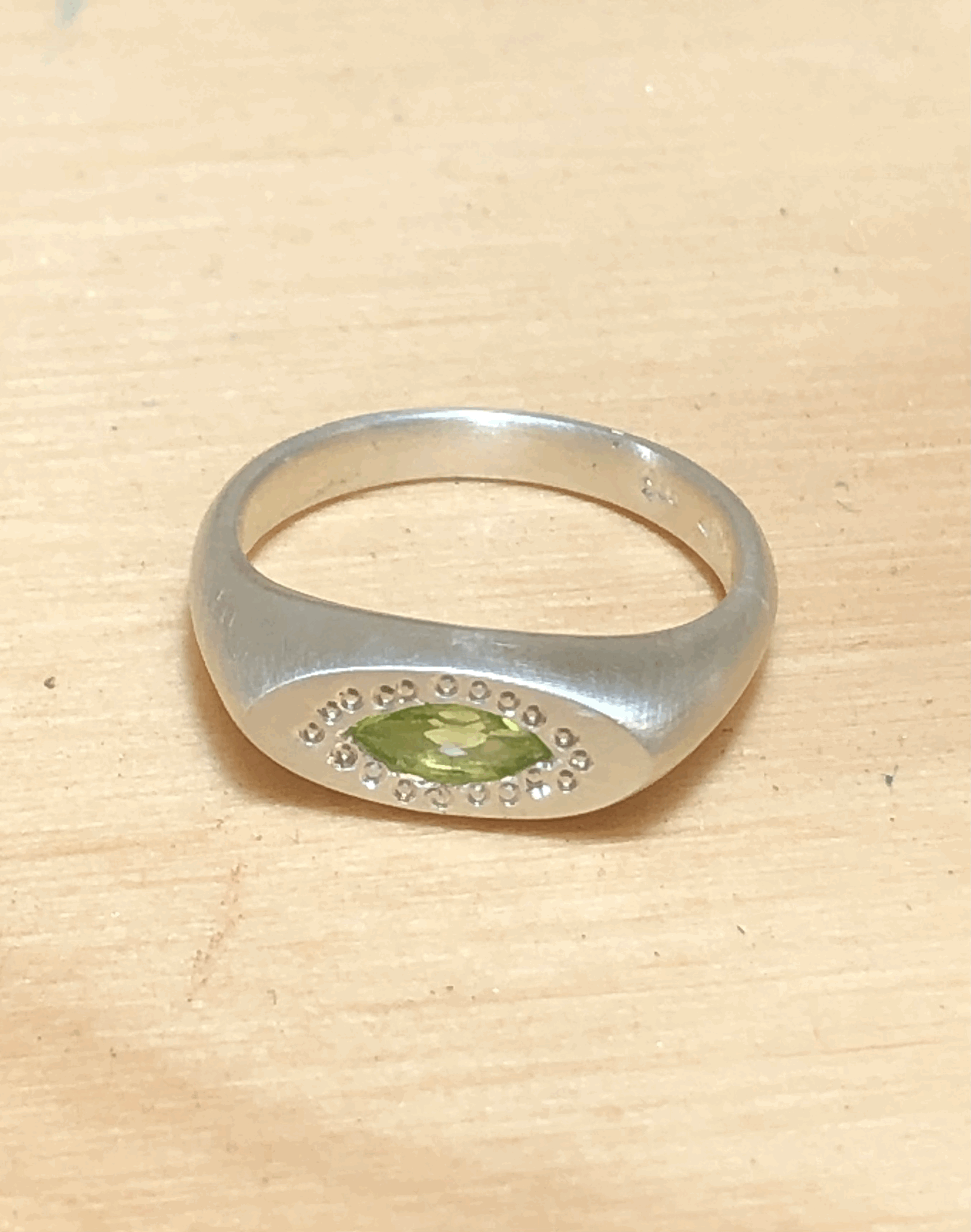 Side profile of Rachel Lambert peridot signet ring showing 2.5mm band width