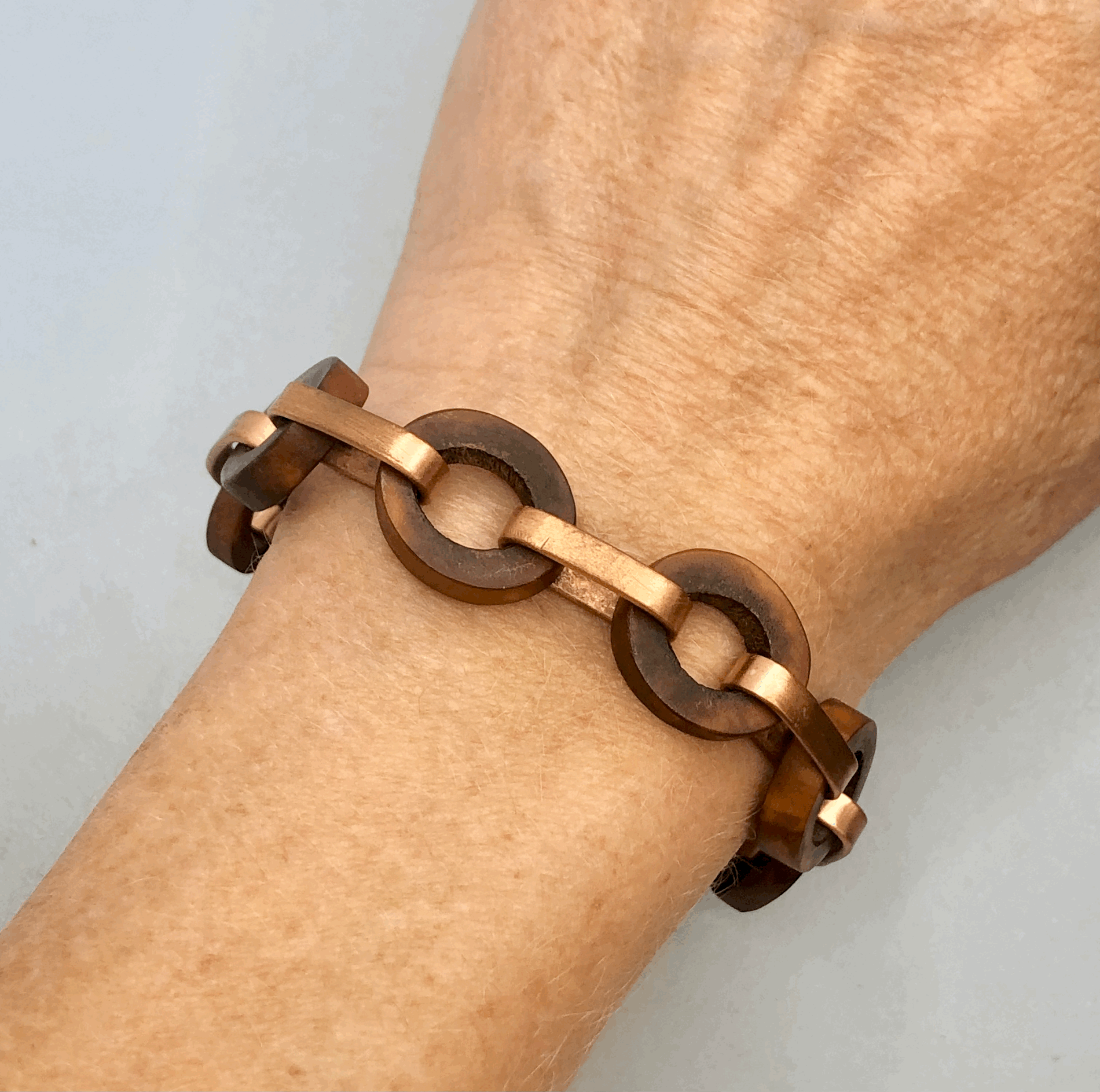 Rachel Lambert antler bracelet lying flat on wrist, showing width and natural tonal variation in the antler