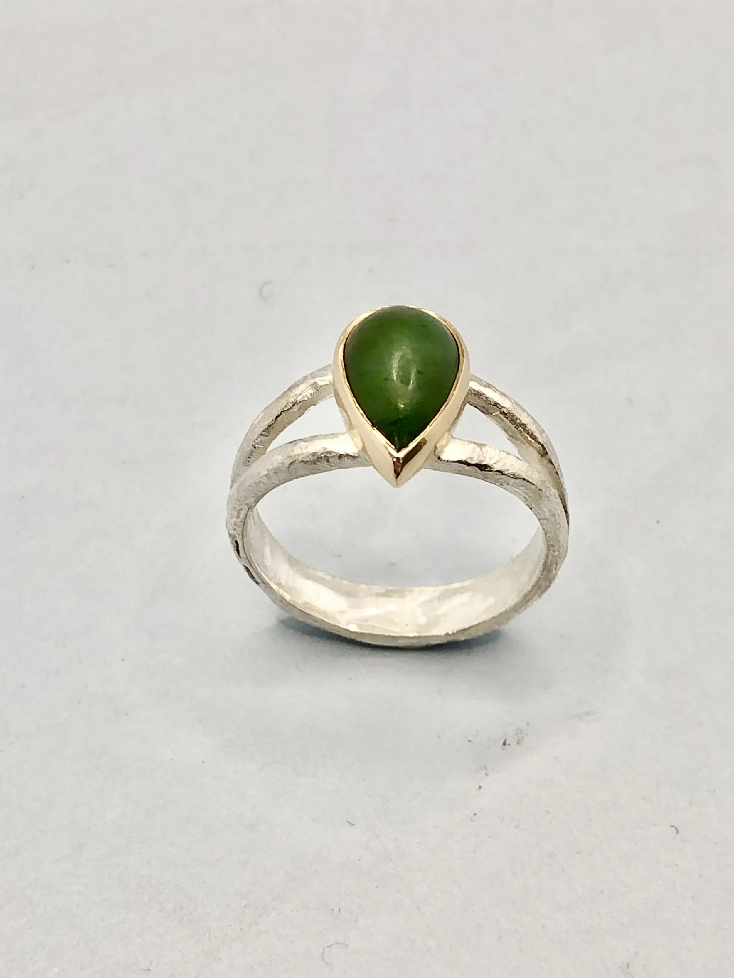 Pounamu teardrop cabochon set in 9k yellow gold on textured split shank sterling silver ring. Rachel Lambert Jewellery