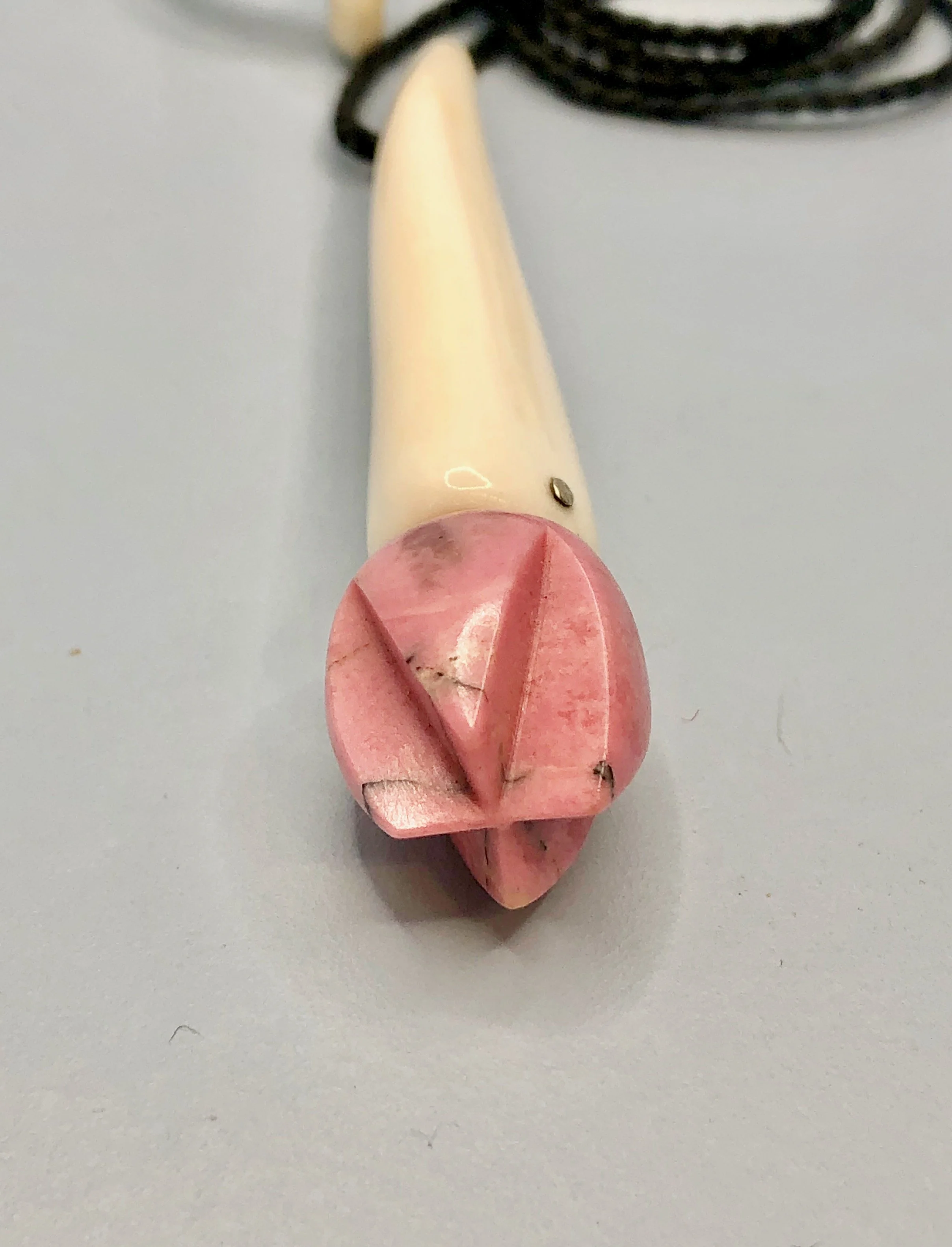 Close-up view of the bottom of the pink rhodonite flower bud pendant