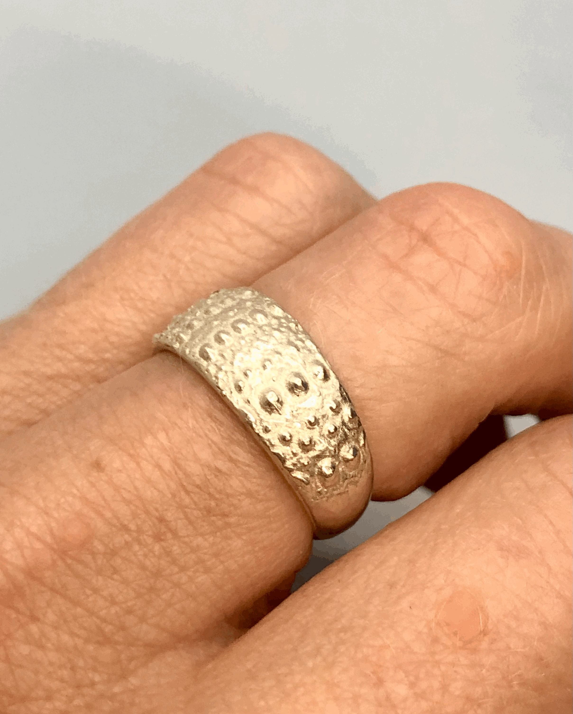 Kina silver ring worn on finger showing fit and scale, handcrafted NZ jewellery