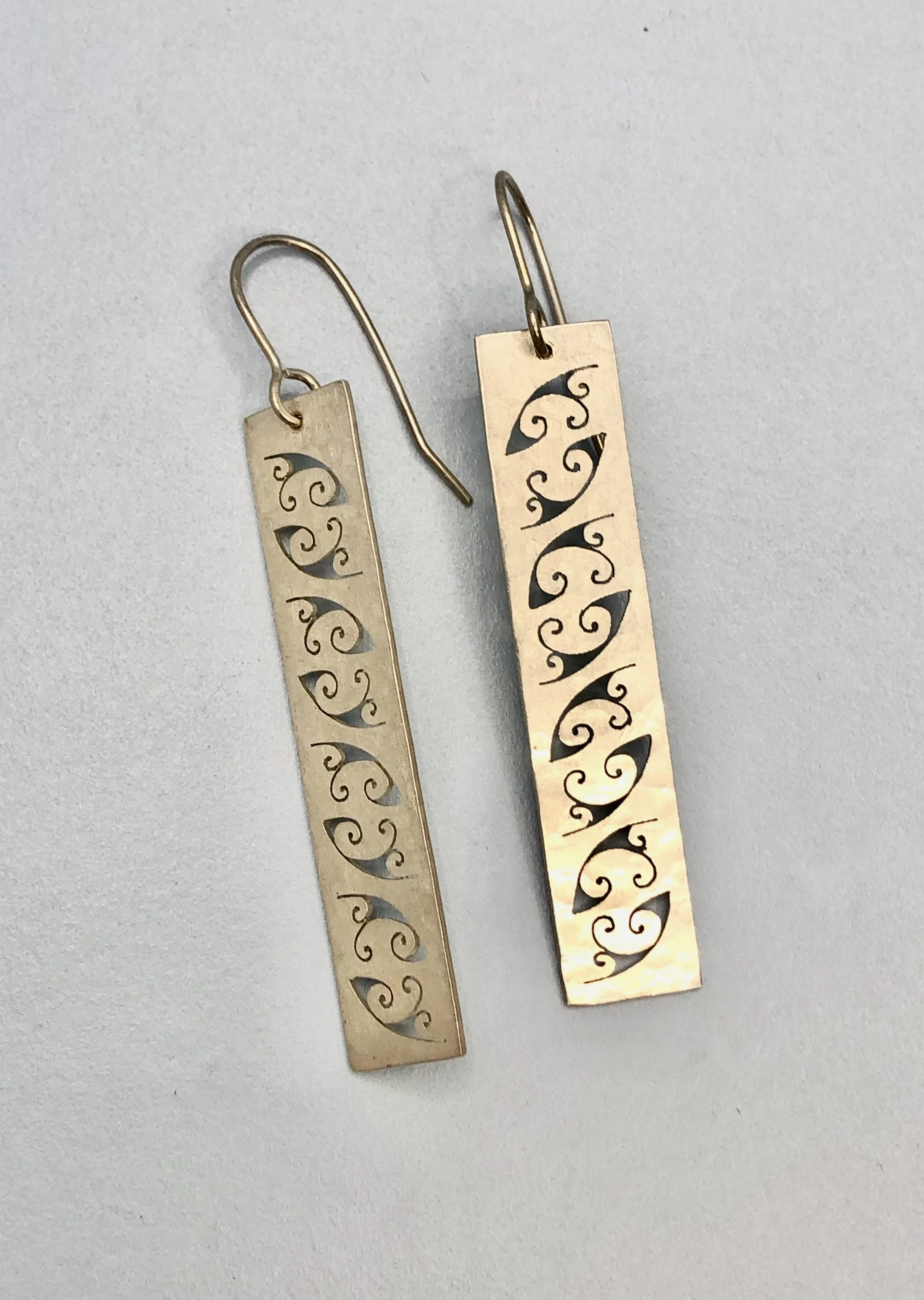 Up close picture of koru pattern earrings