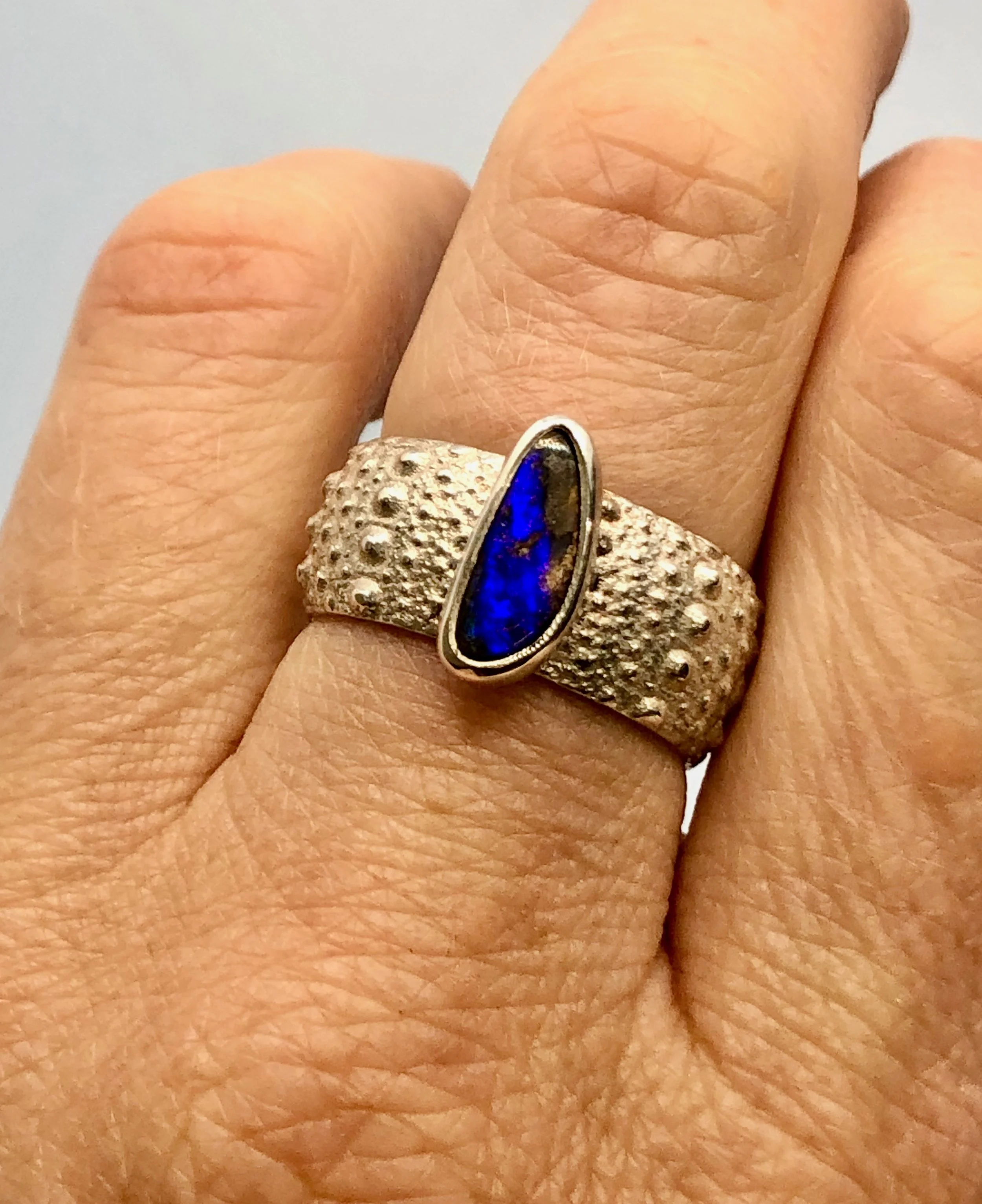 Opal and 925 kina ring worn on a finger to show fit.