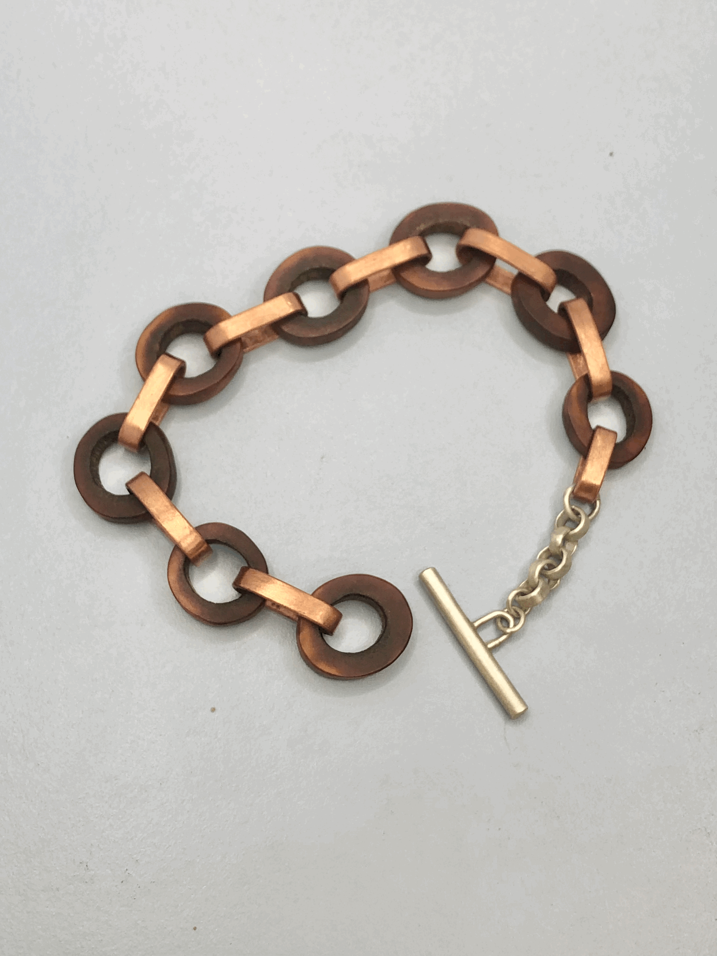 Rachel Lambert antler bracelet lying flat, showing width and natural tonal variation in the antler