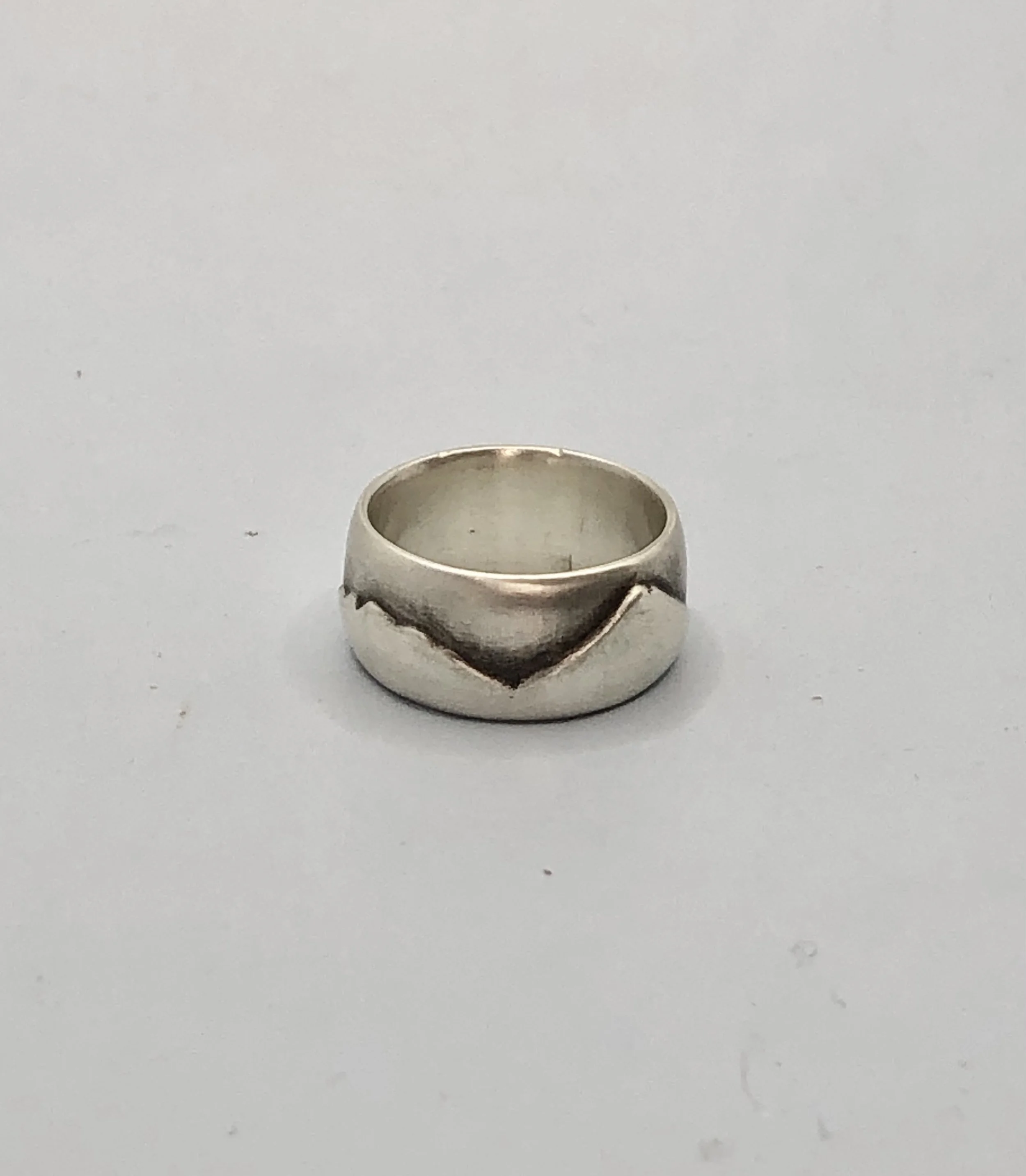 Side profile of Taranaki ranges ring showing hand-carved mountain skyline in sterling silver