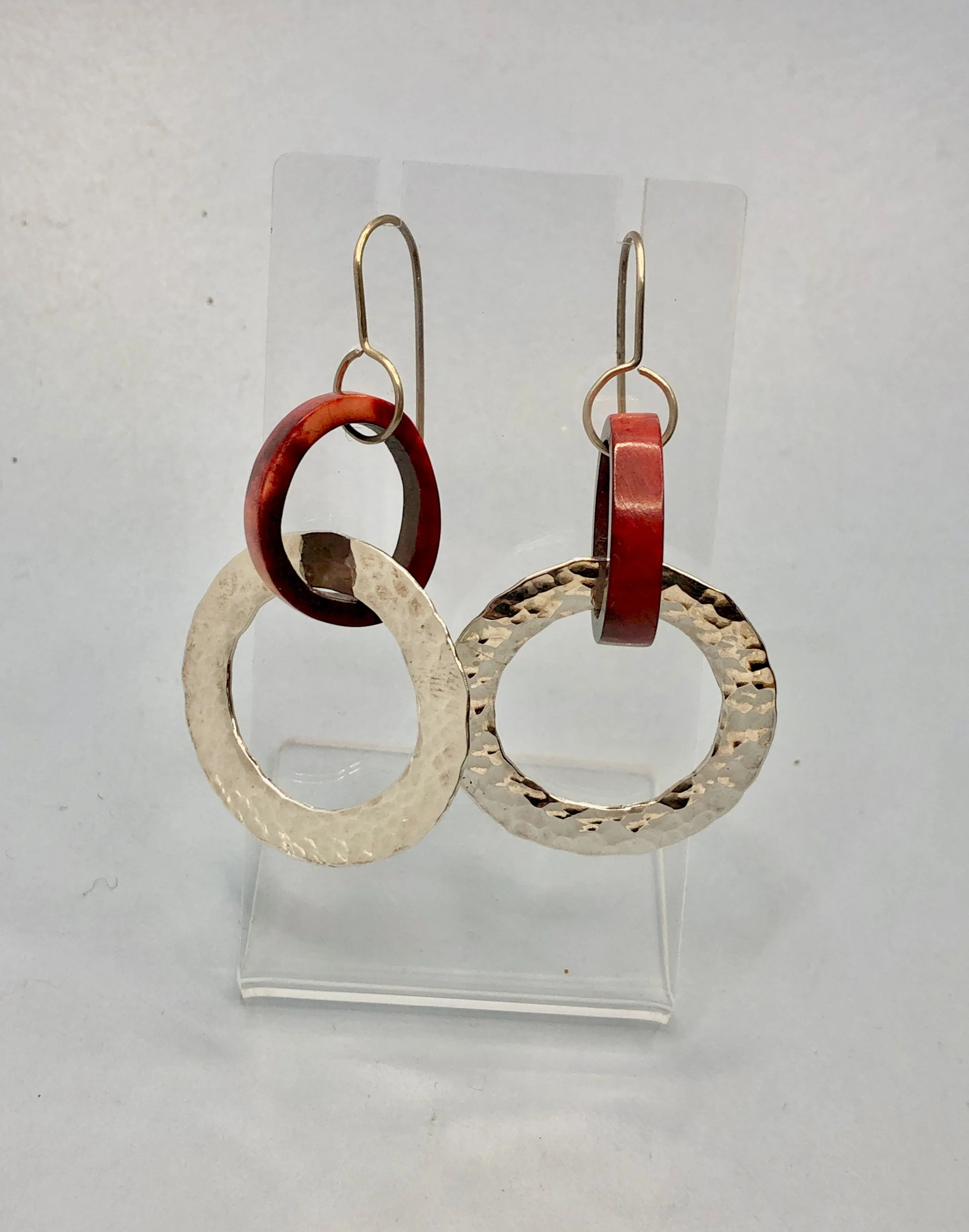 Side view of naturally dyed antler hoop with attached sterling silver textured hoop