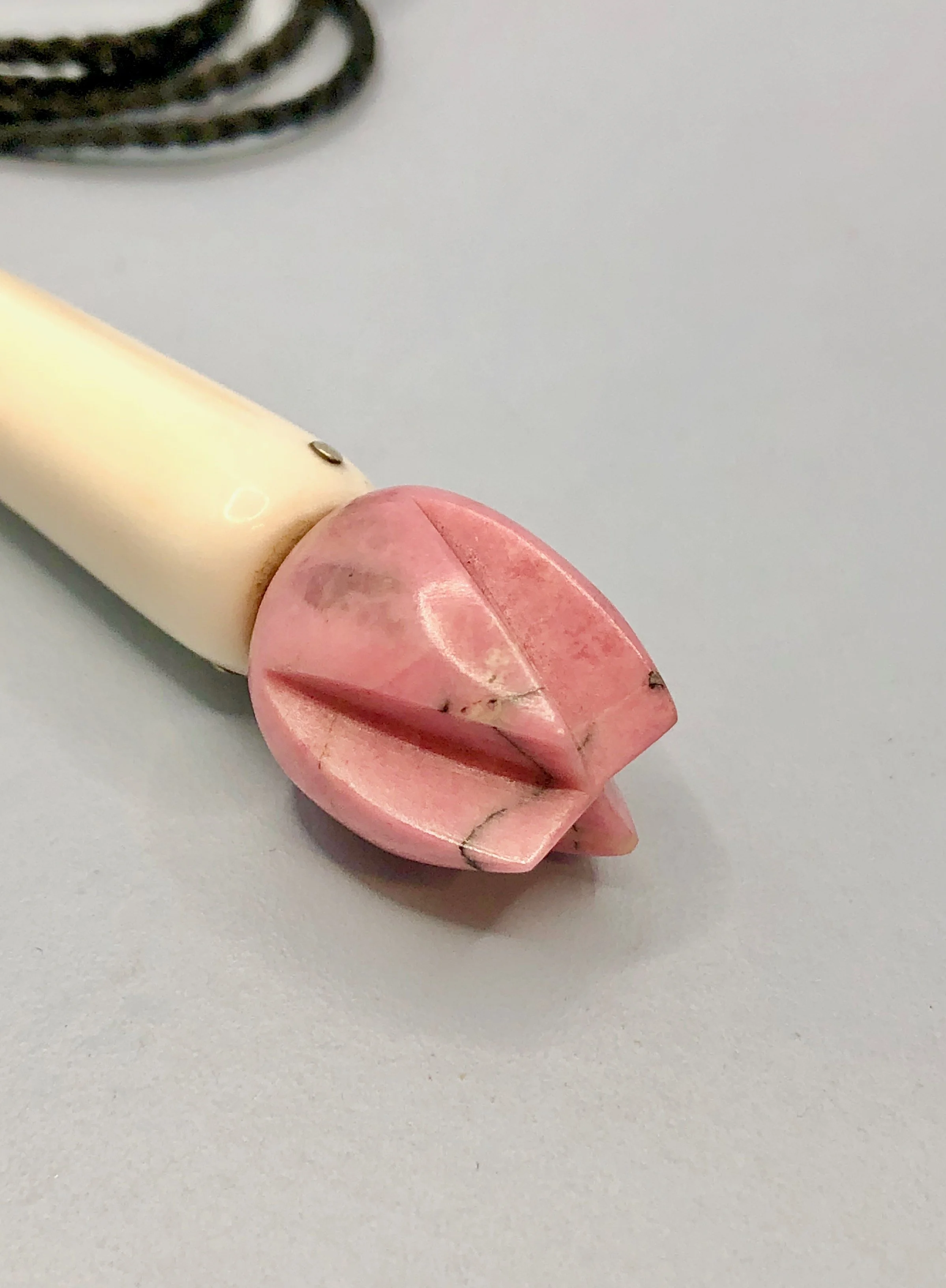 Close-up side view of the pink rhodonite flower bud
