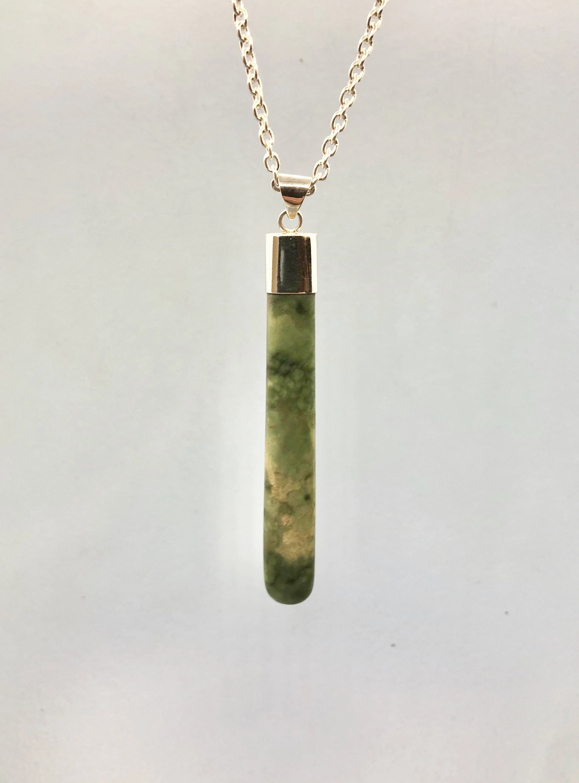 NZ Pounamu pendant shown hanging from 925 cable chain, front side.