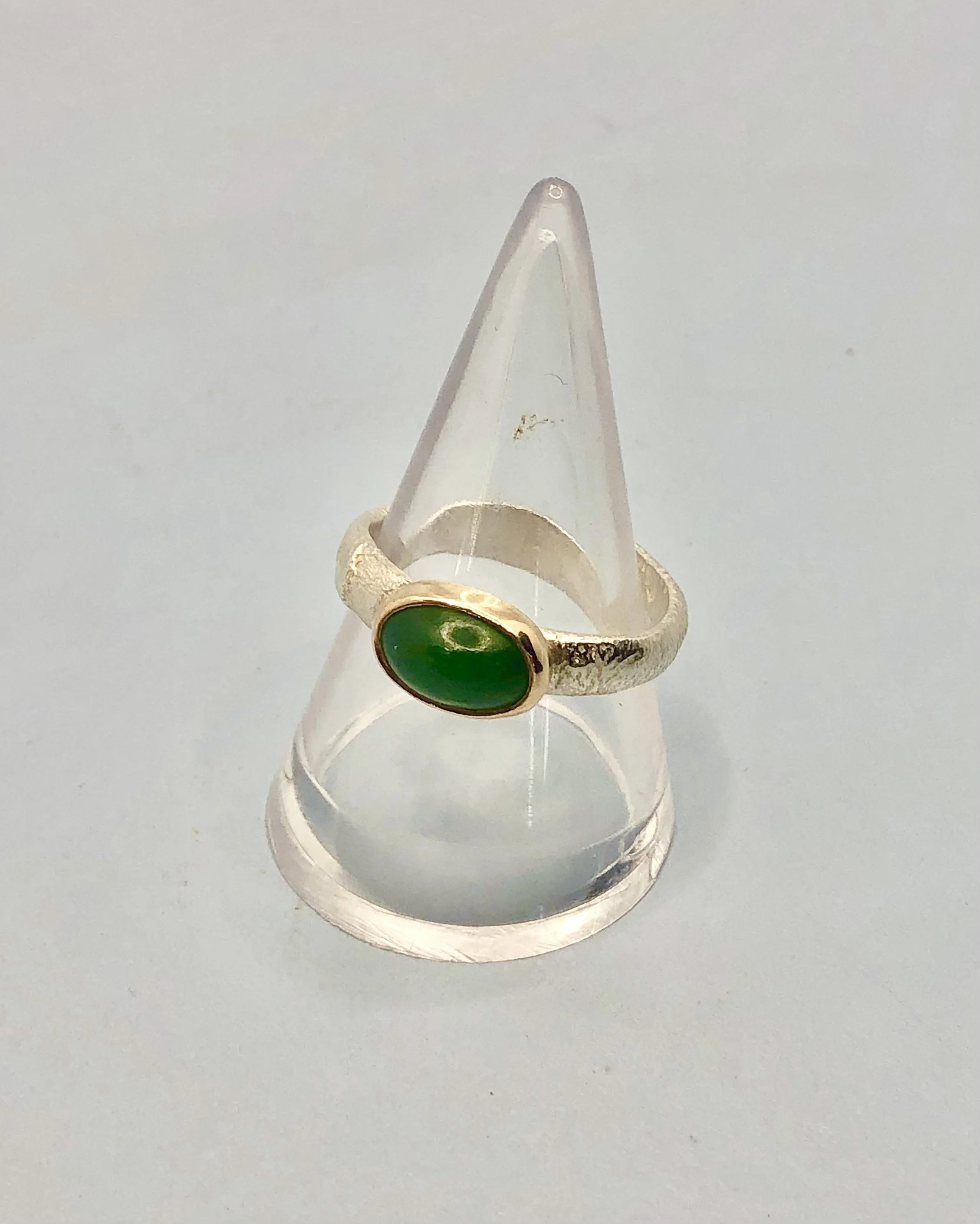 Hand carved oval pounamu ring set in 9k yellow gold and textured sterling silver. Rachel Lambert Jewellery