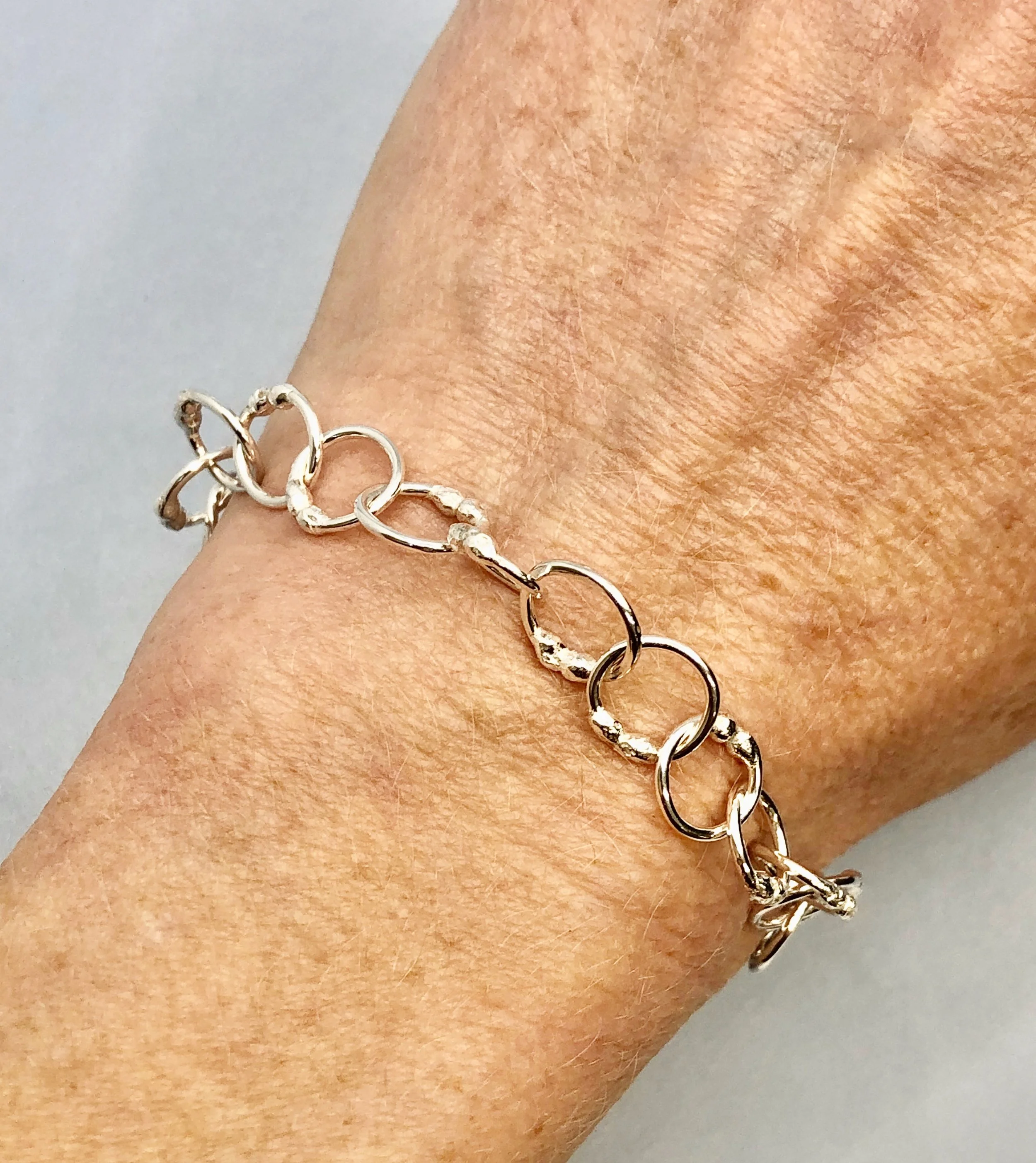 Adjustable sterling silver bracelet worn on wrist